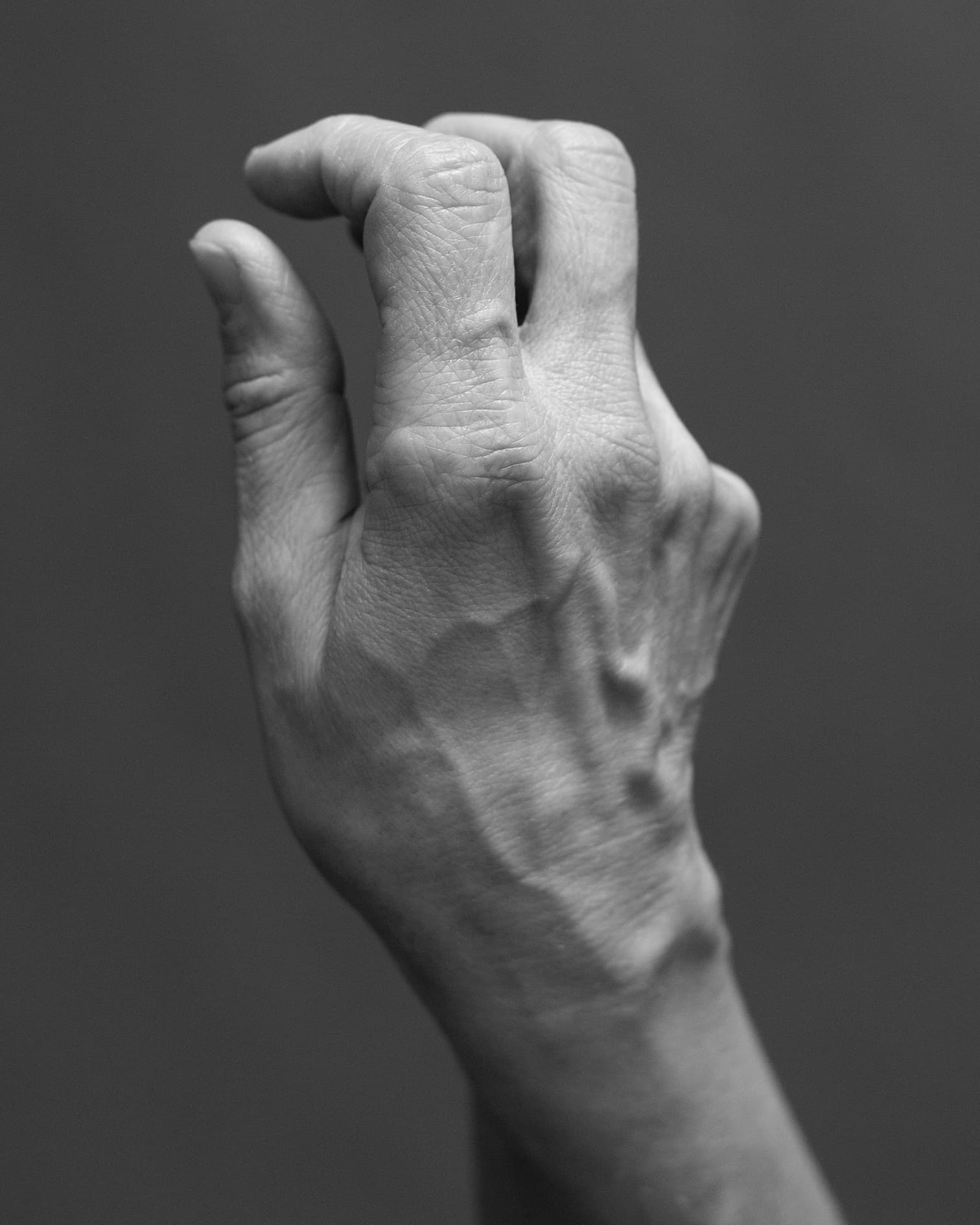 Black and white image of a gesturing hand. © Eleonora Agostini