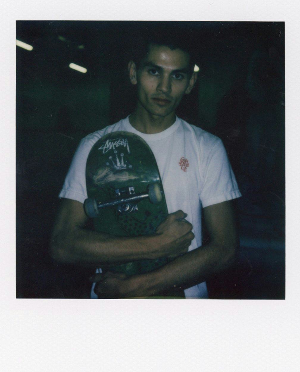 Polaroid of boy with skateboard in hand
