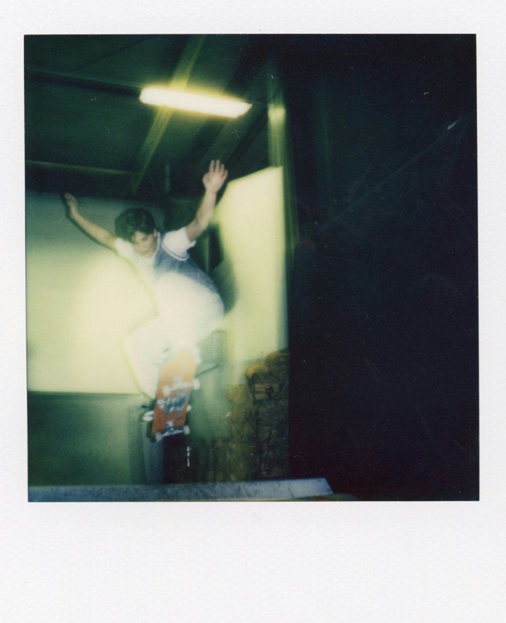 Polaroid of kid skating in air