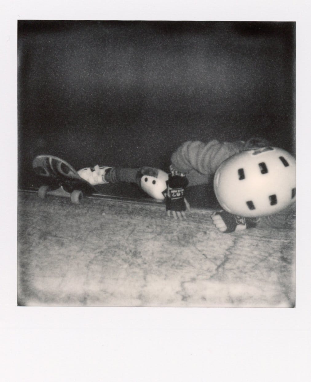 Polaroid of skater climbing up ramp