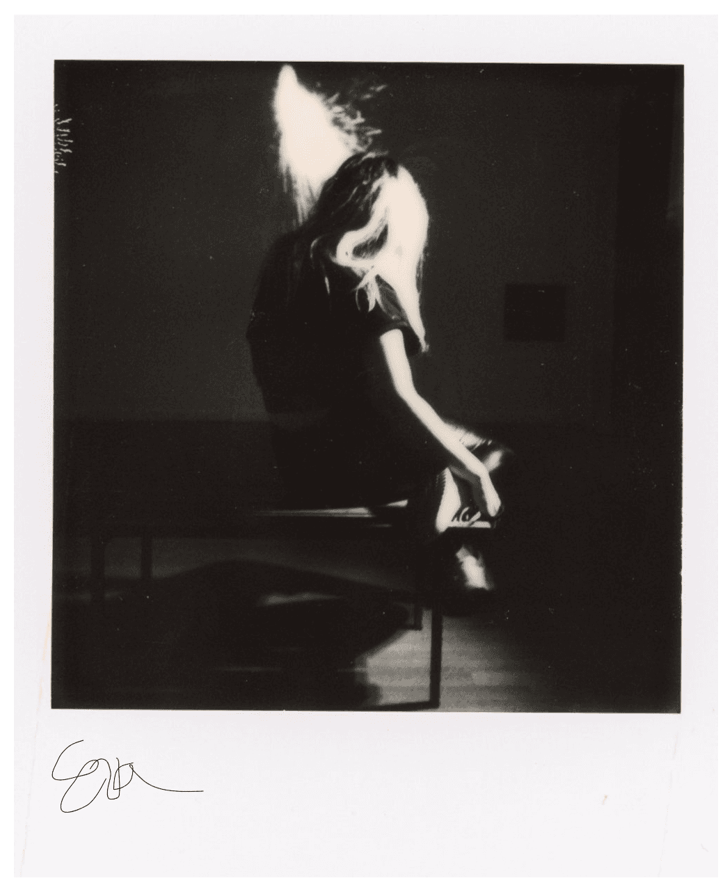 Polaroid of girl sitting on chair BW