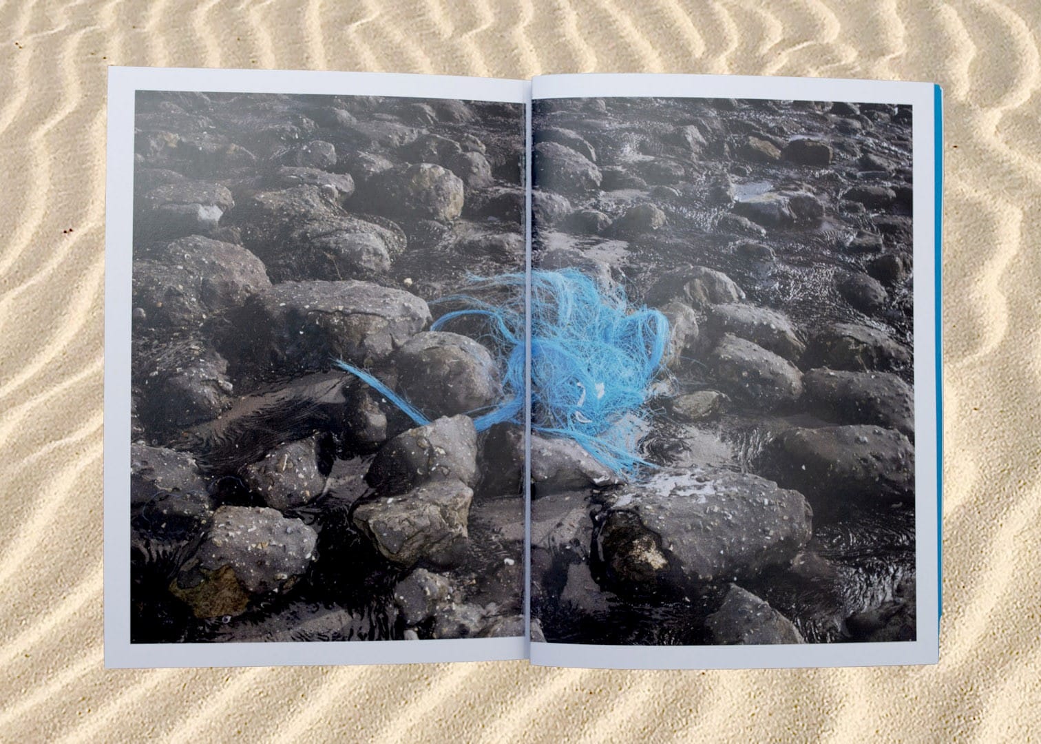image of sand with open book