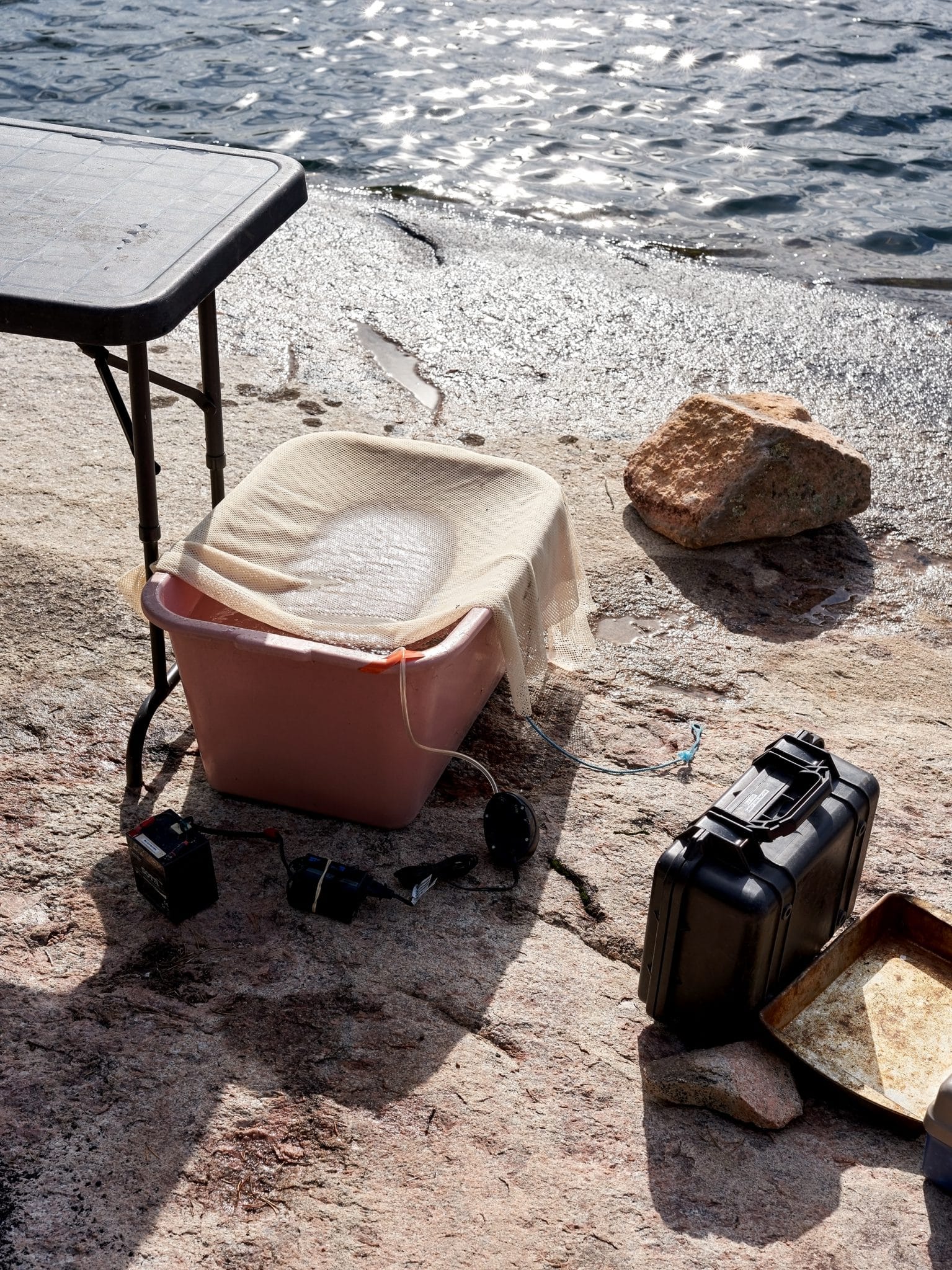 A selection of research equipment standing next the water.