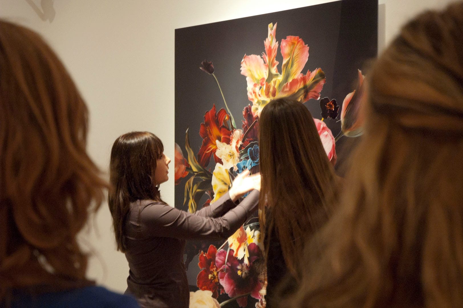 Teacher explaining something in front of a photograph