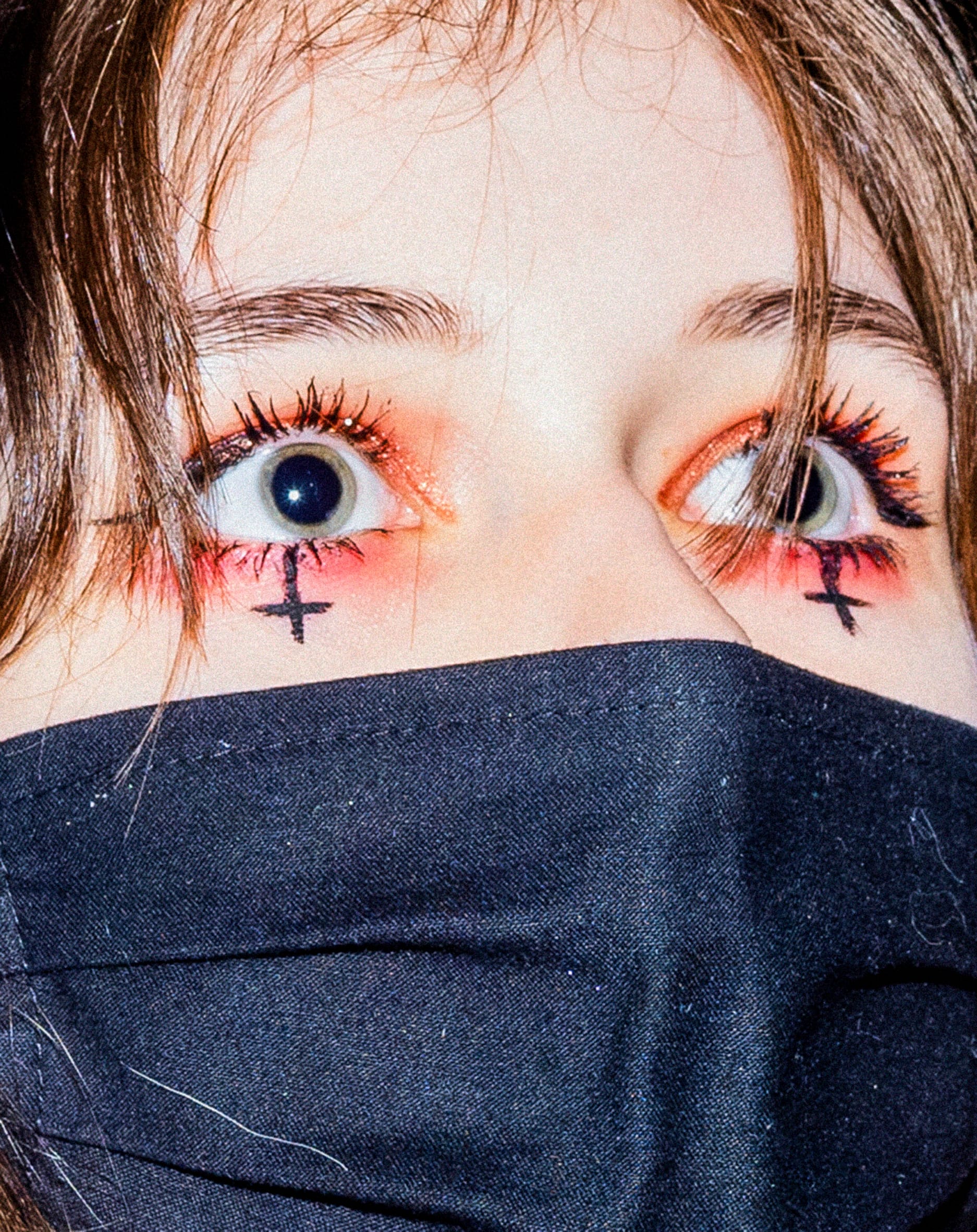 women with eye makeup and facemask