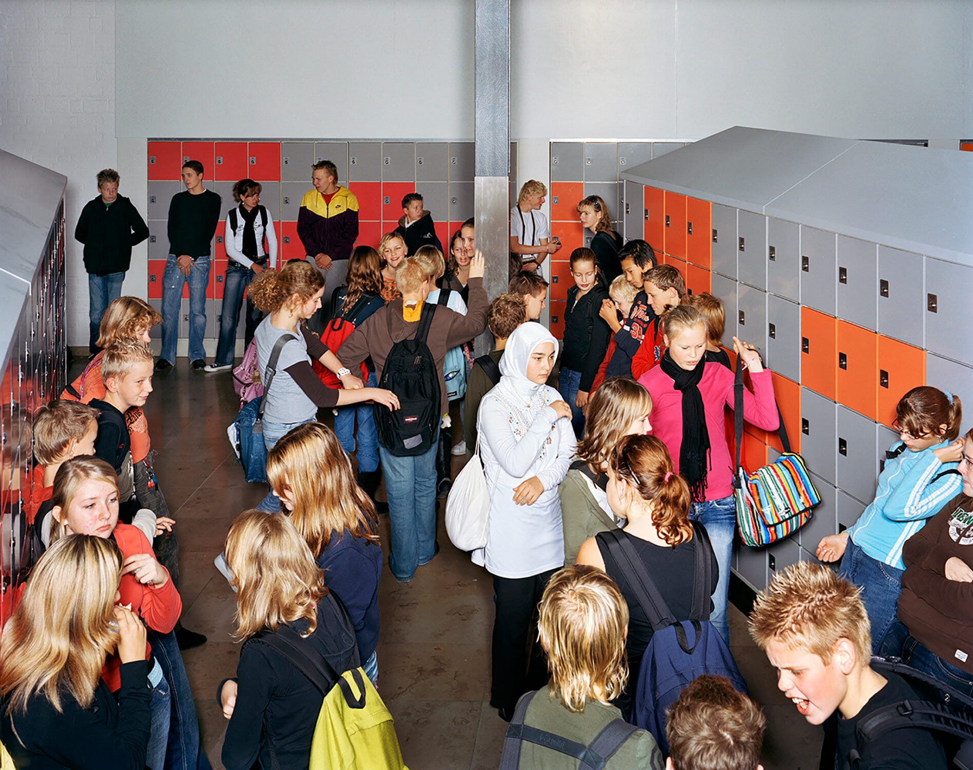 Groep schoolkinderen in de gang met kluisjes van het Veluws college