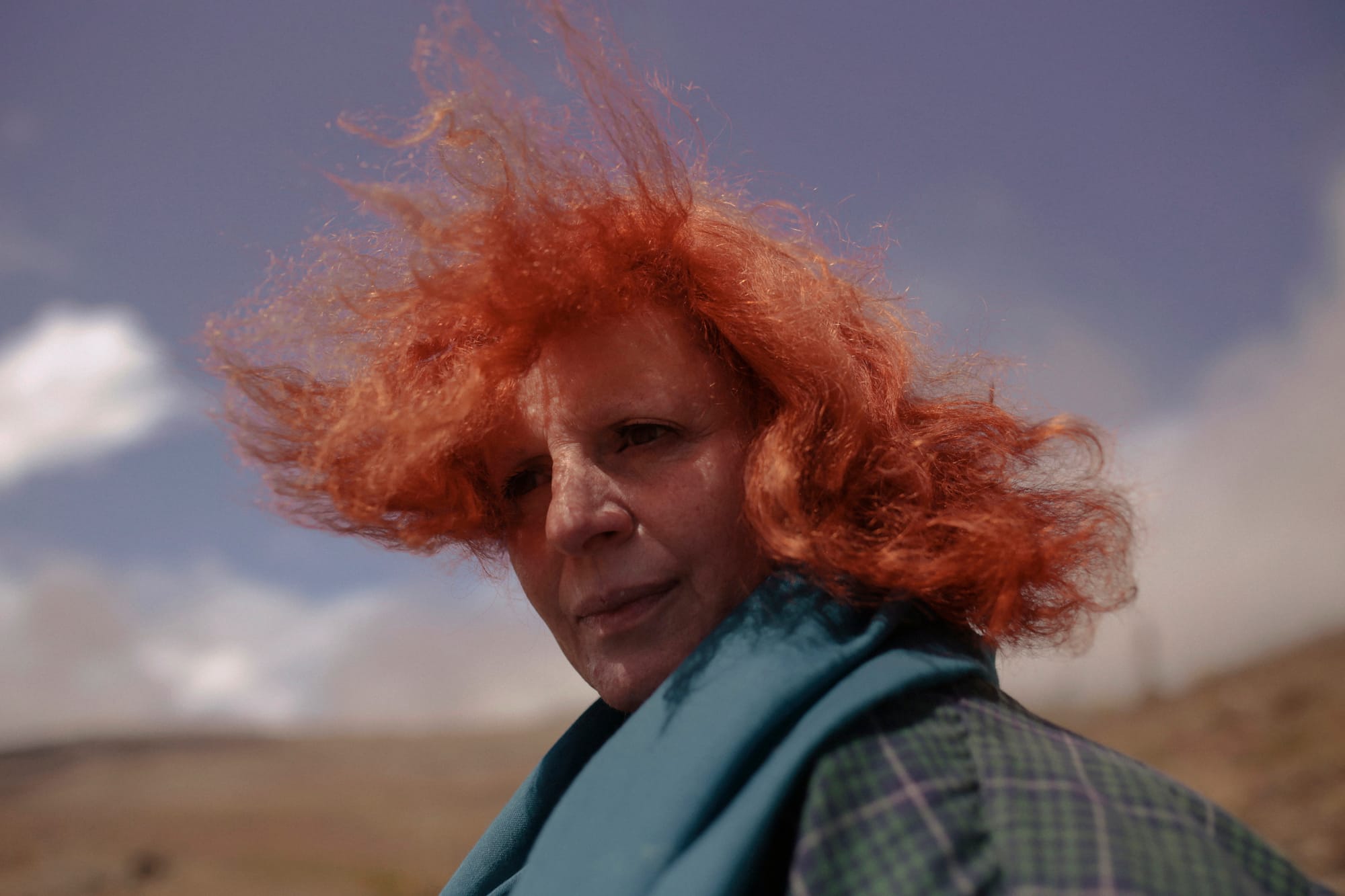 Portrait of the artist's mother, looking back at the camera, hair blowing in the wind. © Cansu Yıldıran