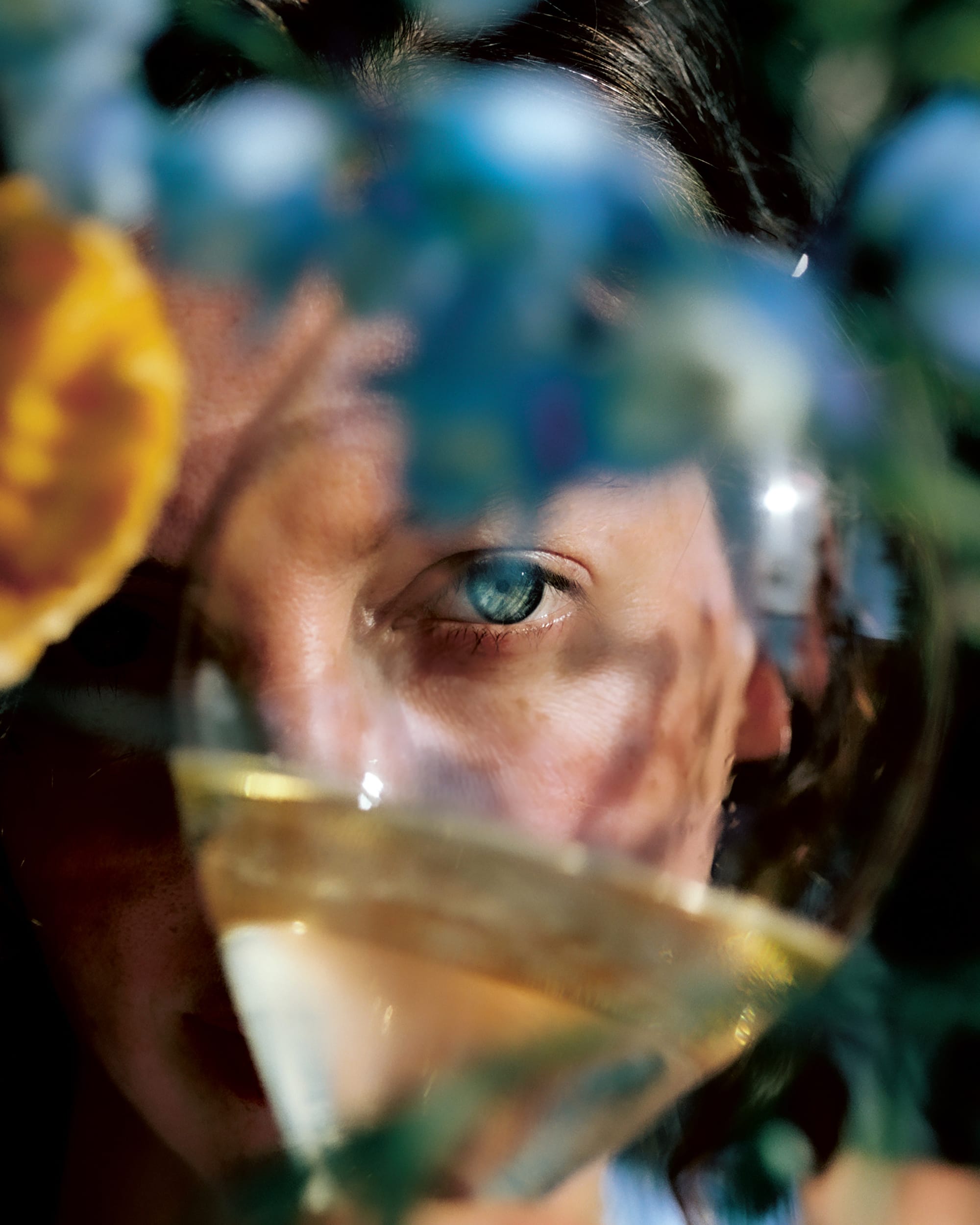 person looking through glass of wine