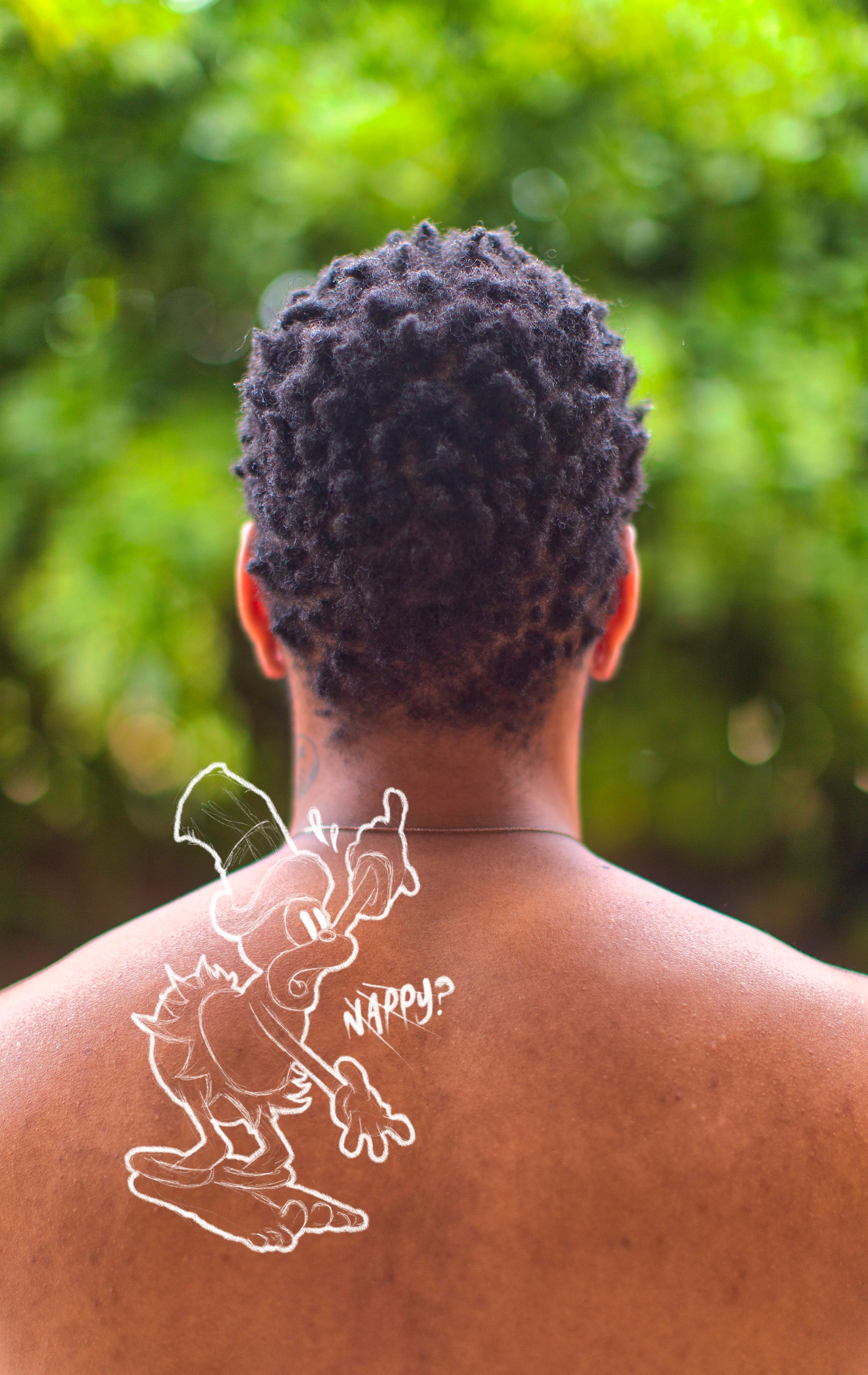 Picture of the back of a Black person, with a drawing on top © André Ramos-Woodard