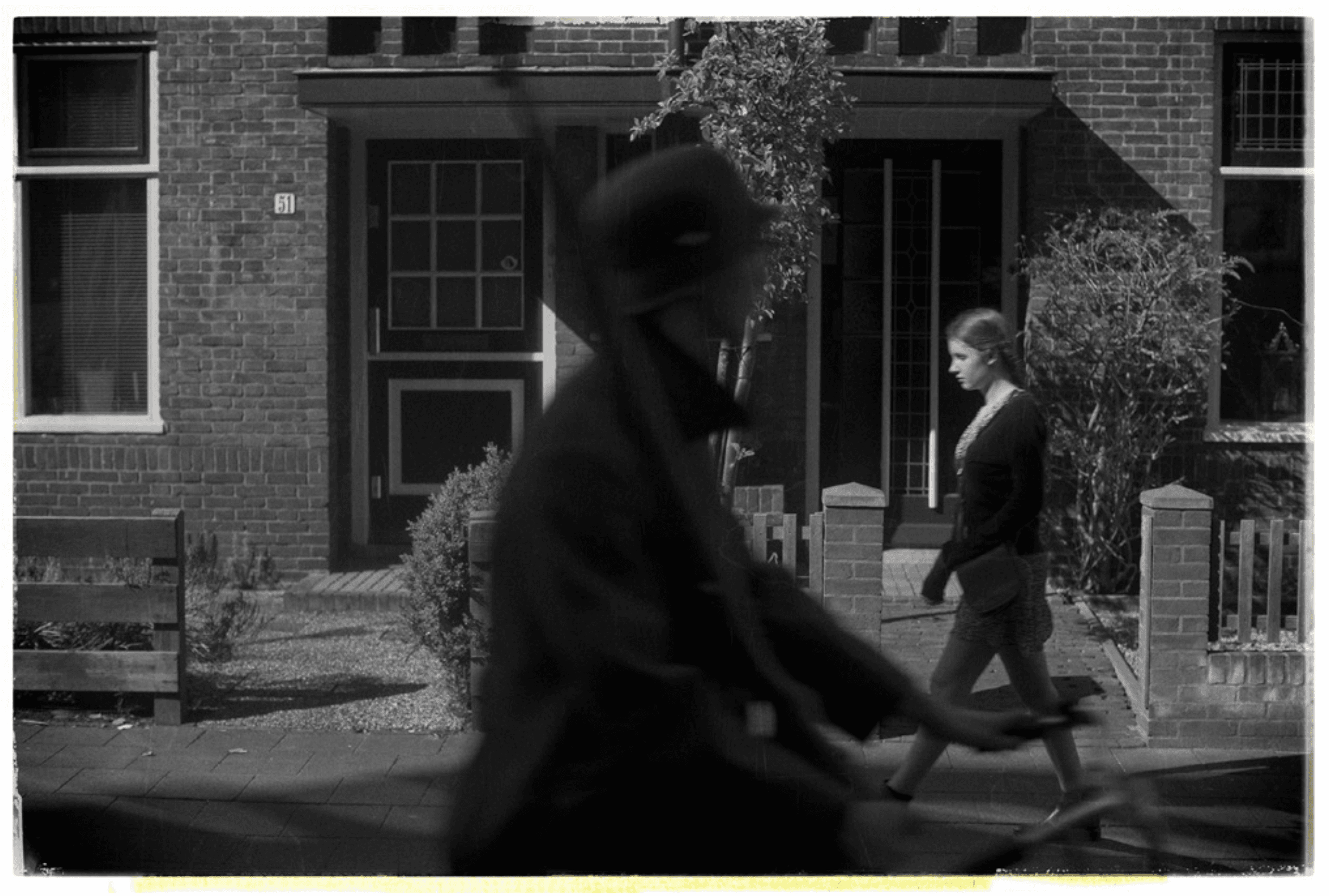 B&W two people walking passed eachother