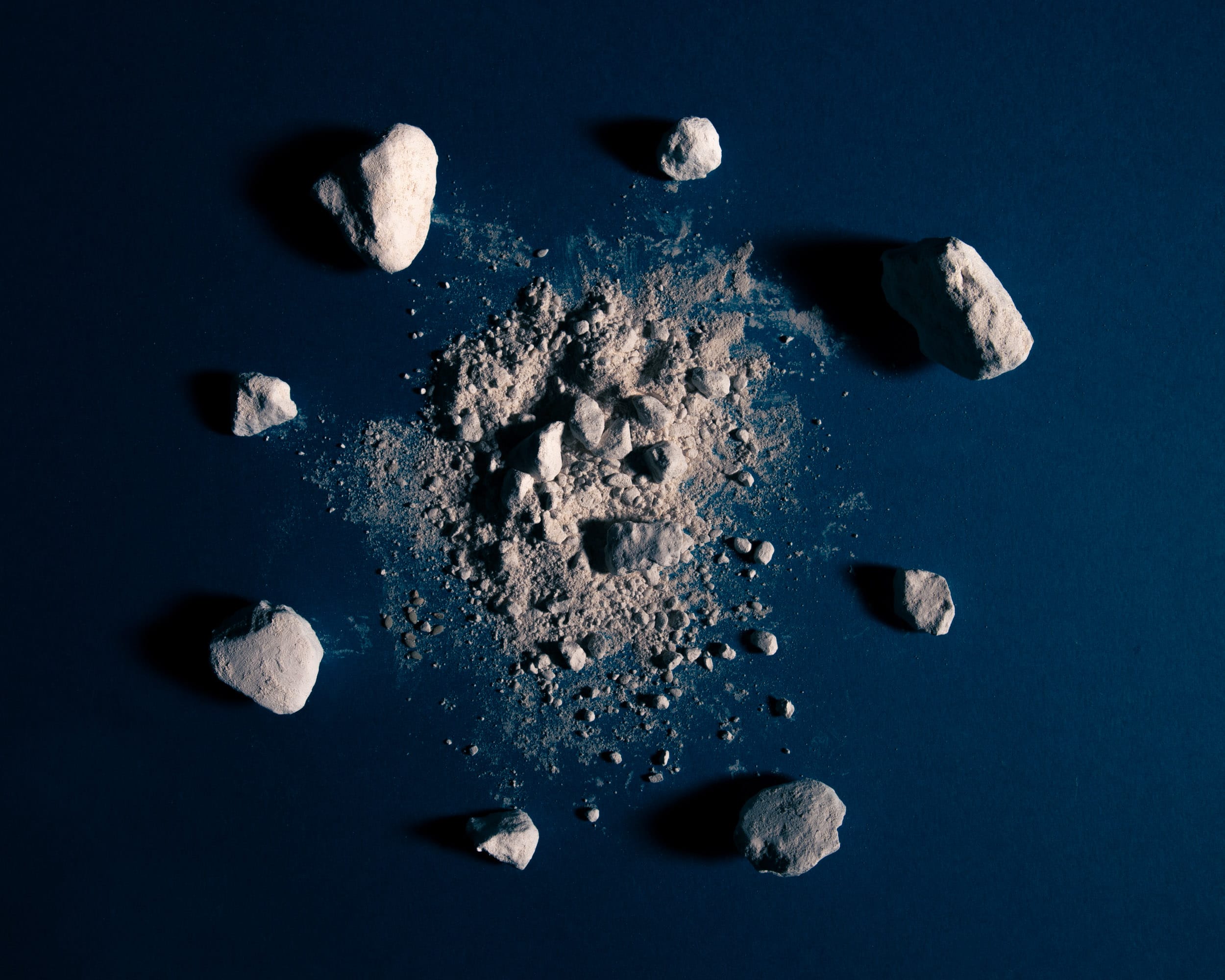 Photo of rocks and sand on a blue background. © Iyanla Etnel