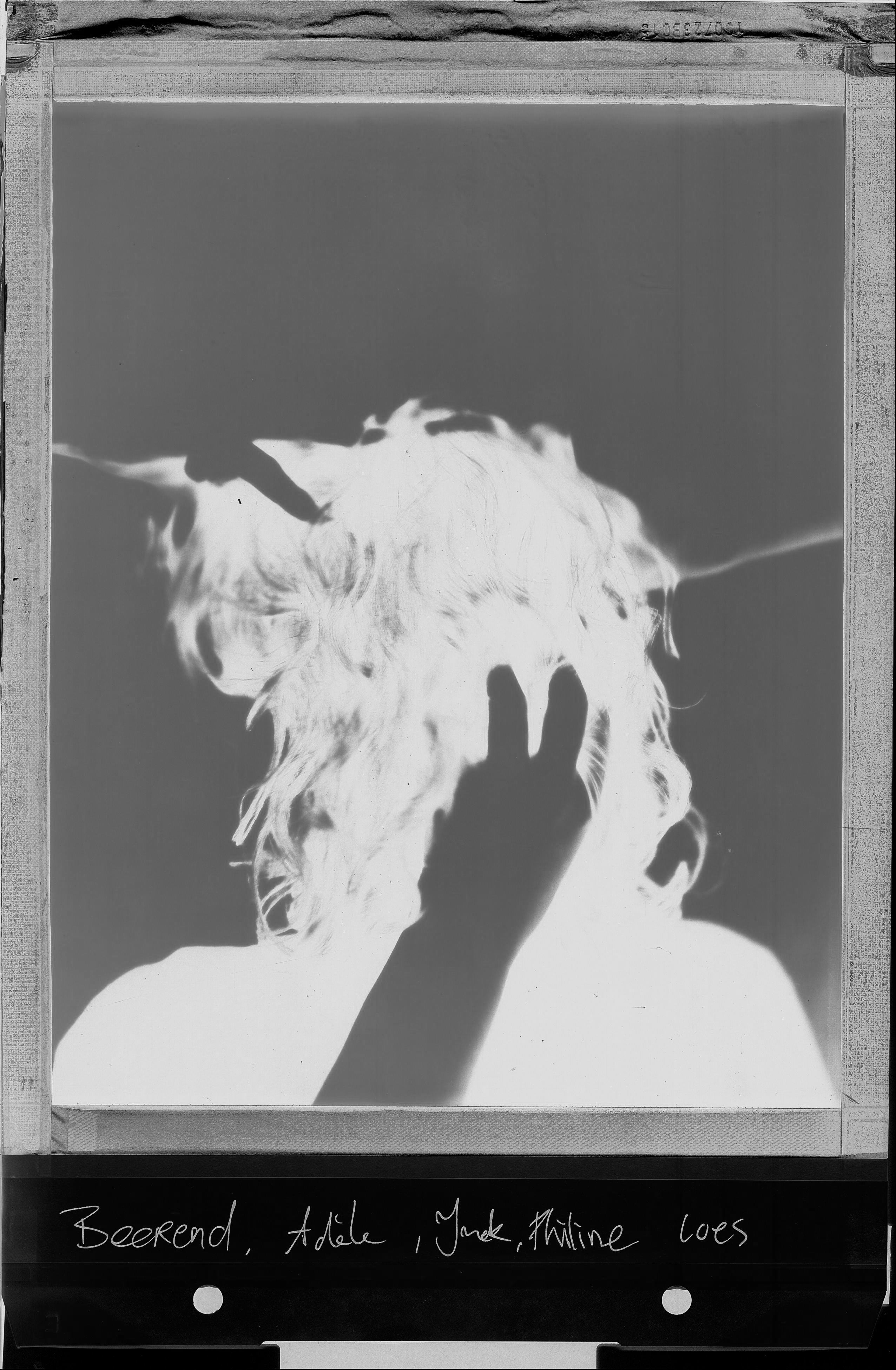 Polaroid portrait turned around woman hands touching hair BW