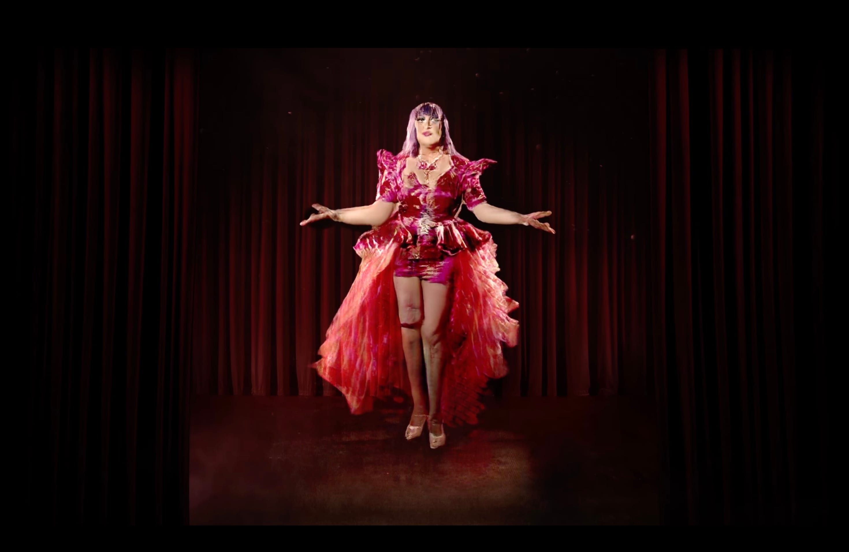 Film still from an AI generated video work, showing an artificial drag queen dancing on a stage.  © Jake Elwes