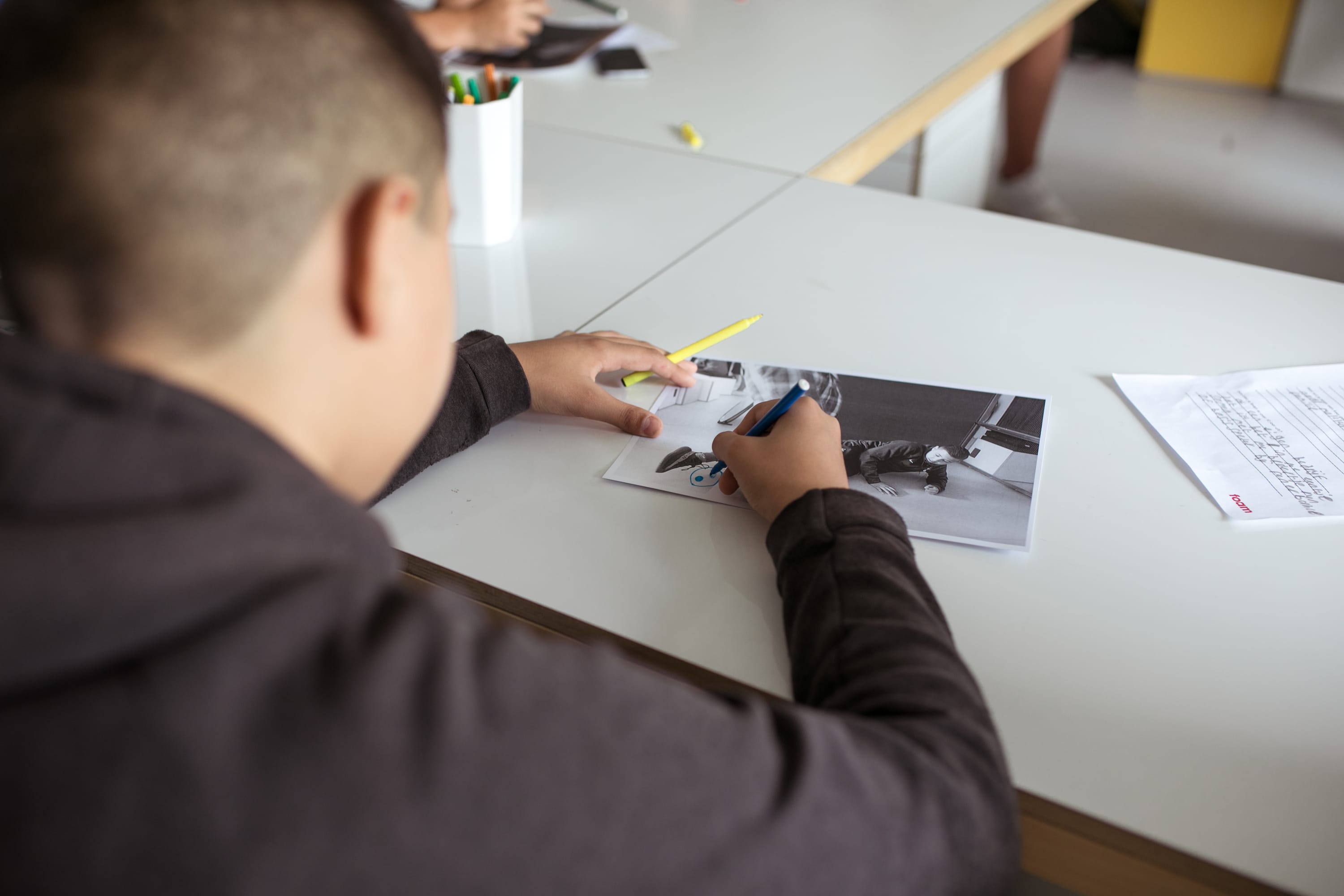 Photo of a child drawing on a photograph