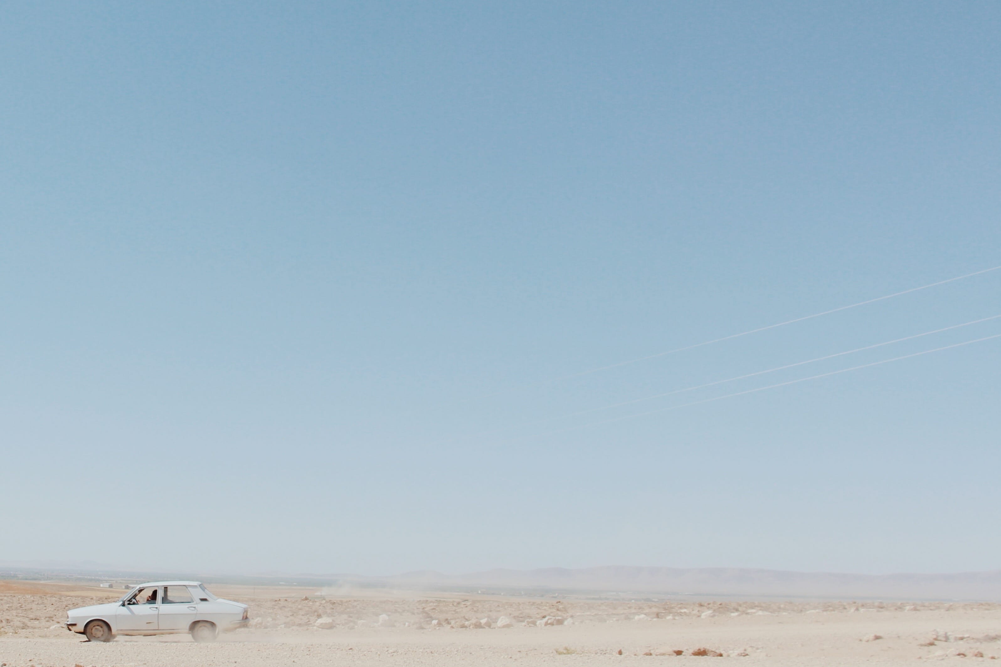 A Renault Toros (the Turkish-built version of the R12) navigating through a vast, open landscape, symbolizing solitude and the exploration of my identity. © Yasemin Demirözcan