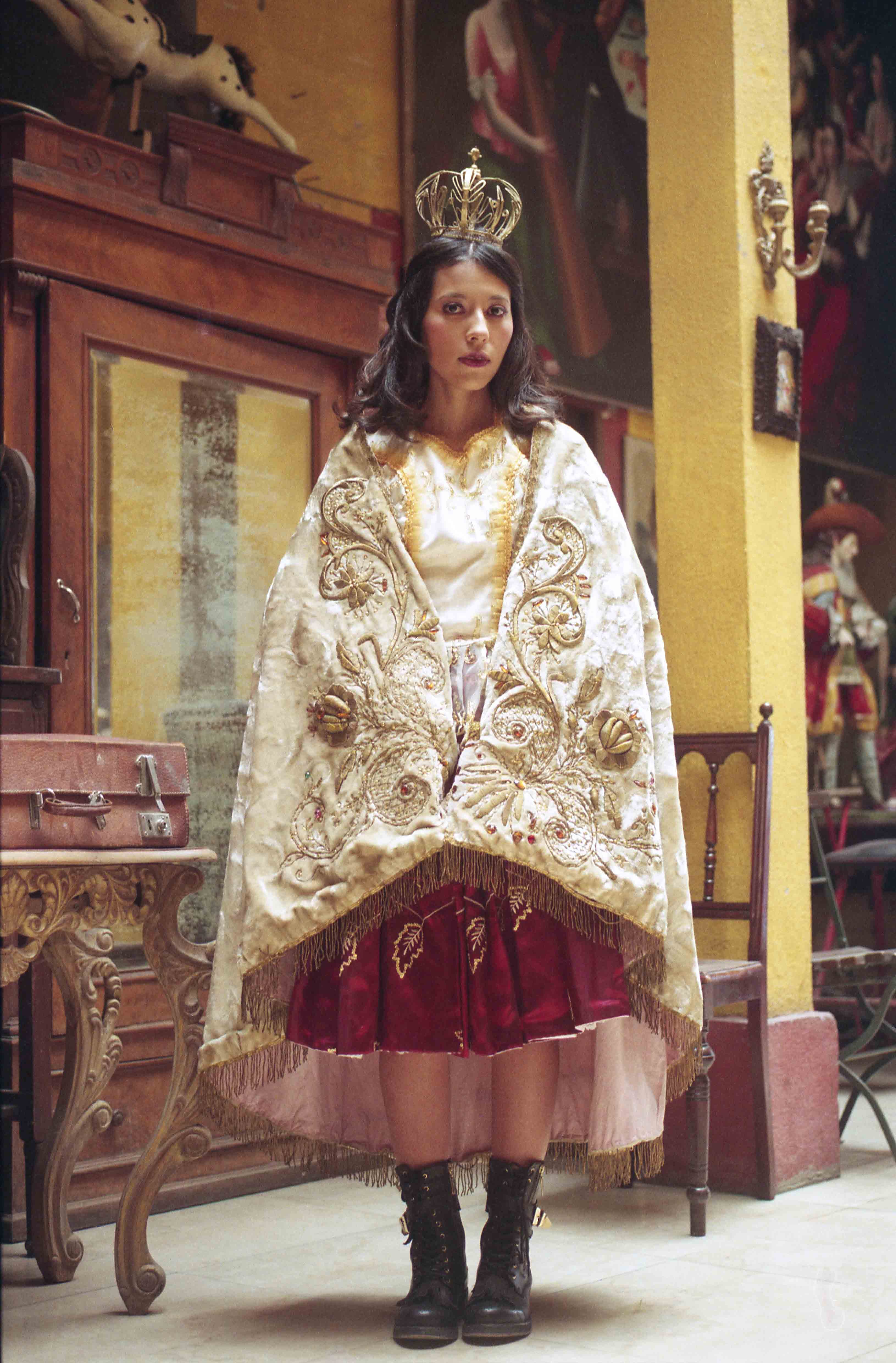 Portrait of a young woman dressed in elaborately decorated dress and a golden crown © Marisol Mendez