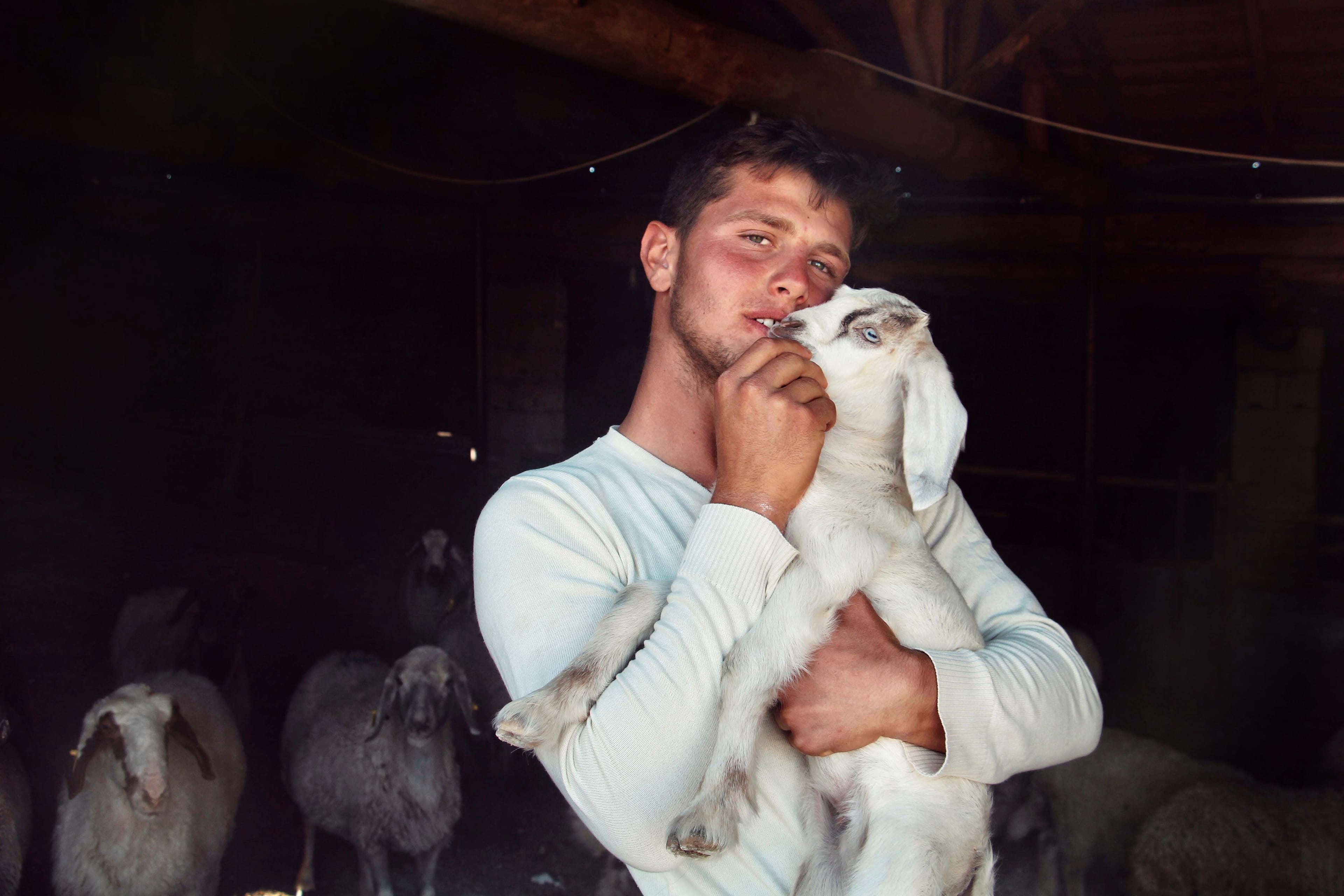 Ali with a baby goat that was born 2 weeks prior to my visit. © Yasemin Demirözcan