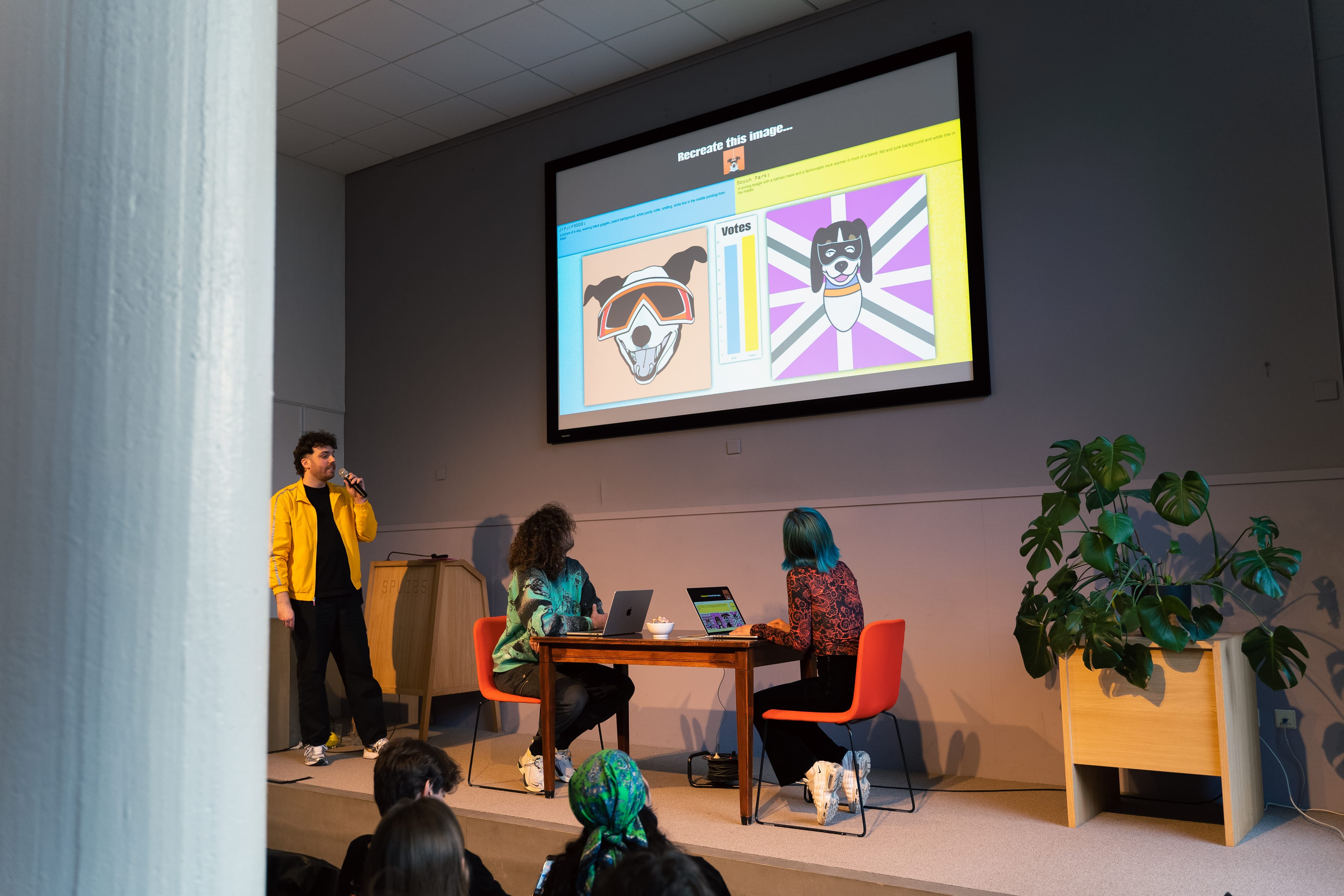 Stage with two persons behind laptops