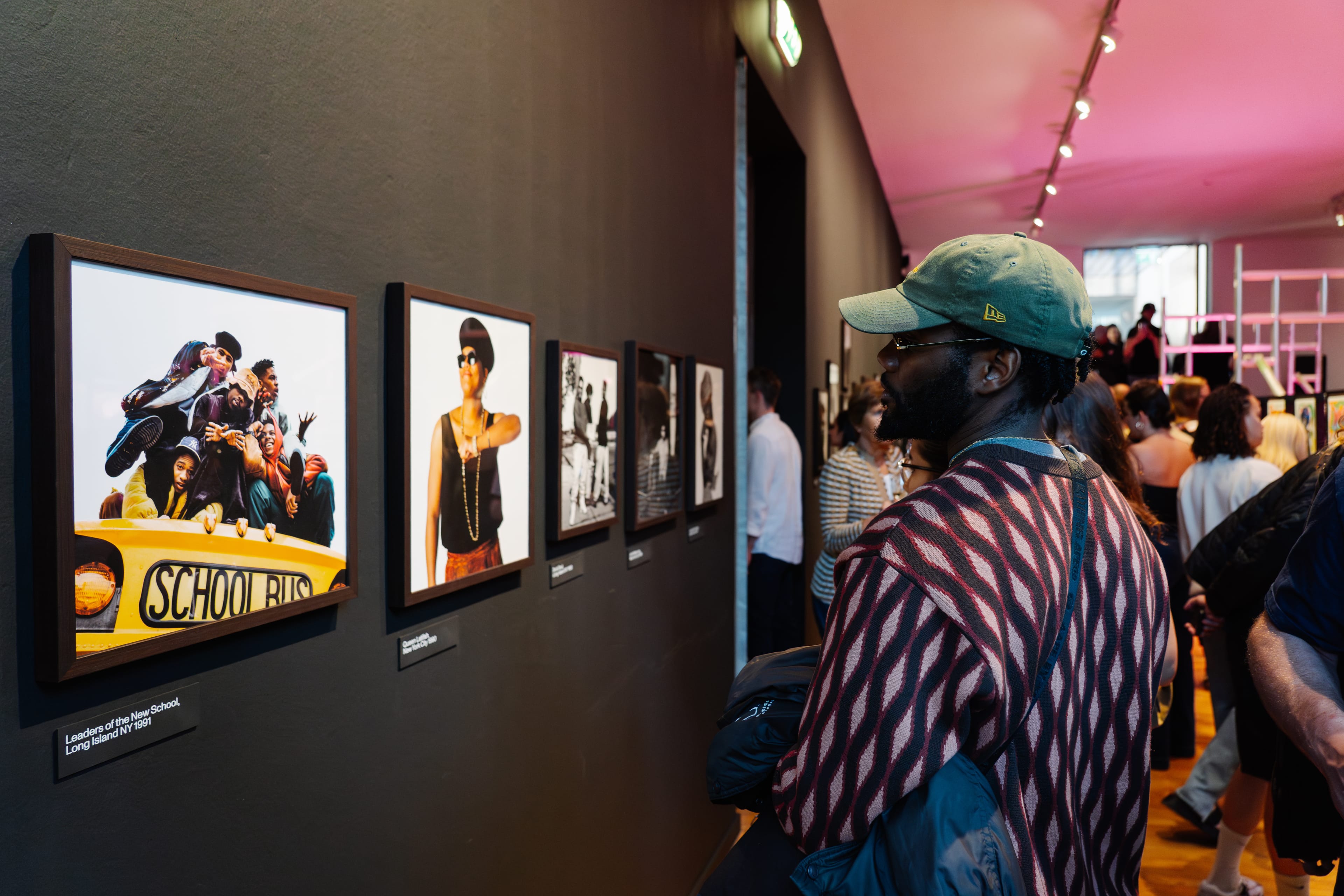 Person looking at photos from the Janette Beckman exhibition at Foam