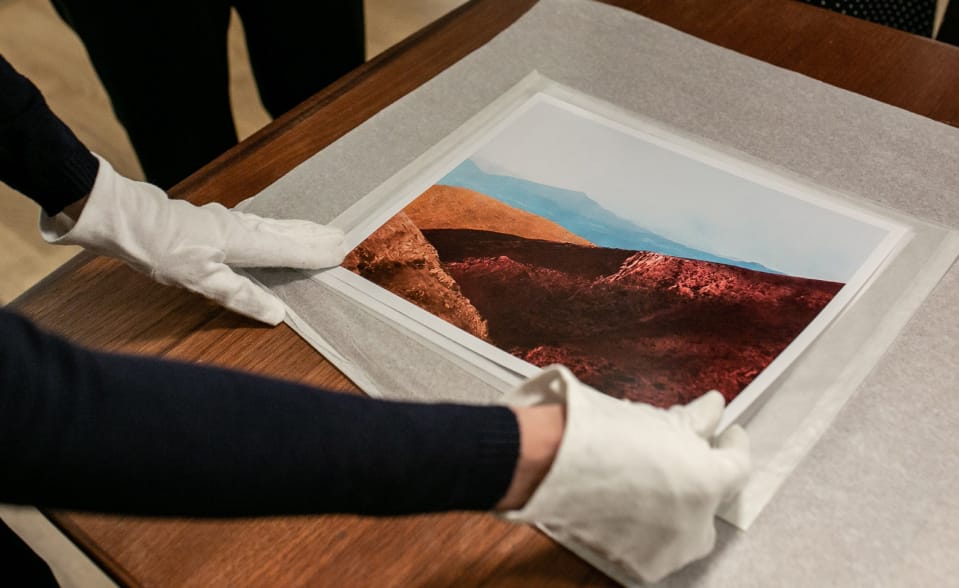 Person holding print with gloves