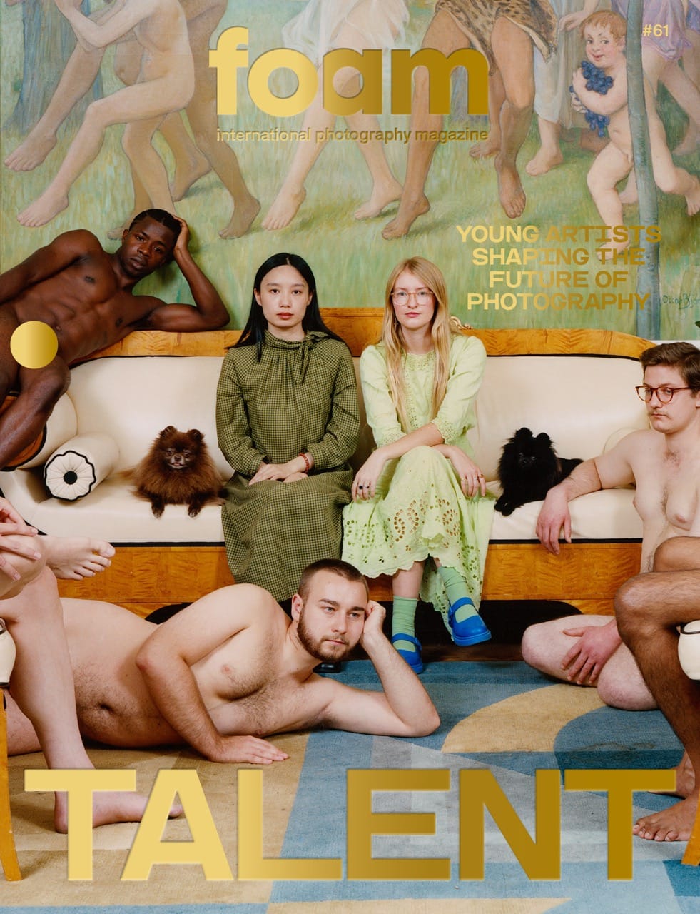 A diverse group of people in colorful outfits and nude poses sit and stand around a couch with small dogs, set against an artistic backdrop.