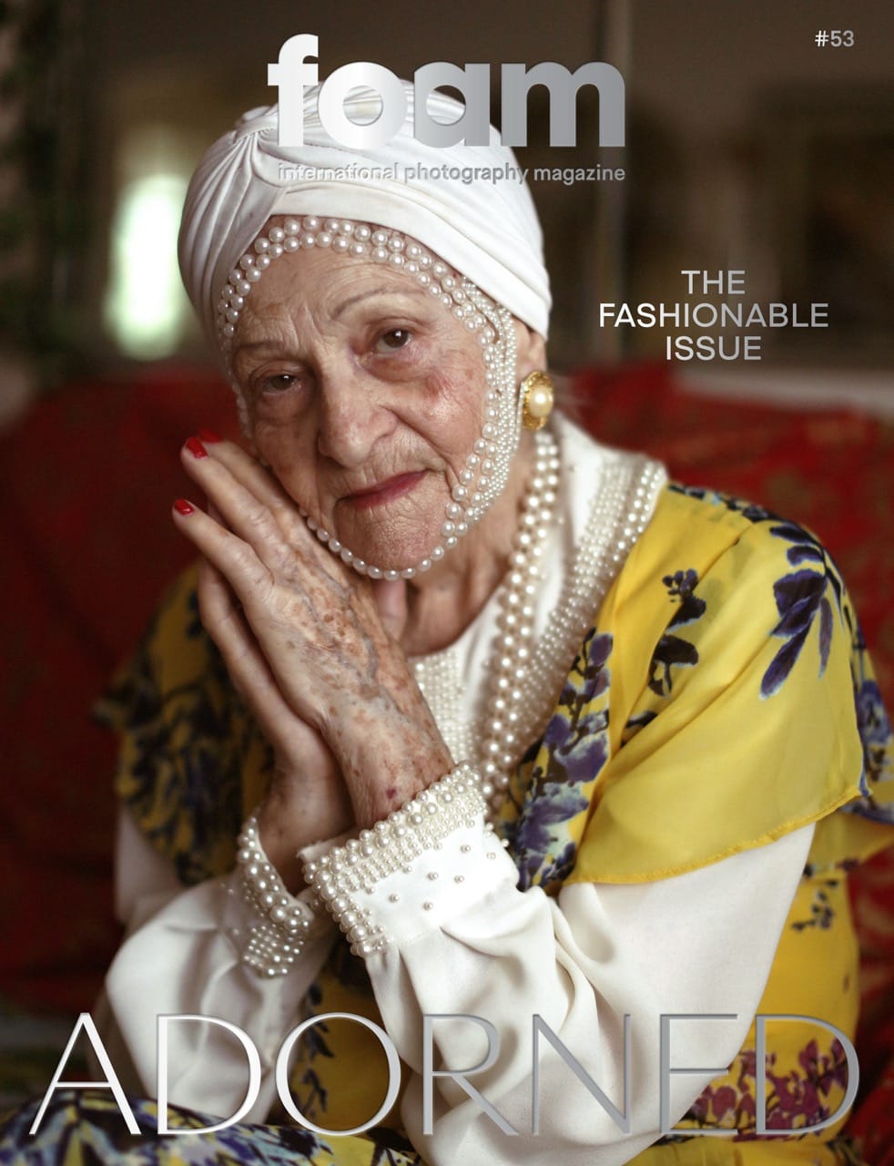 Elderly woman in floral attire and pearl headpiece, hands clasped, on the cover of Foam magazine's "The Fashionable Issue."
