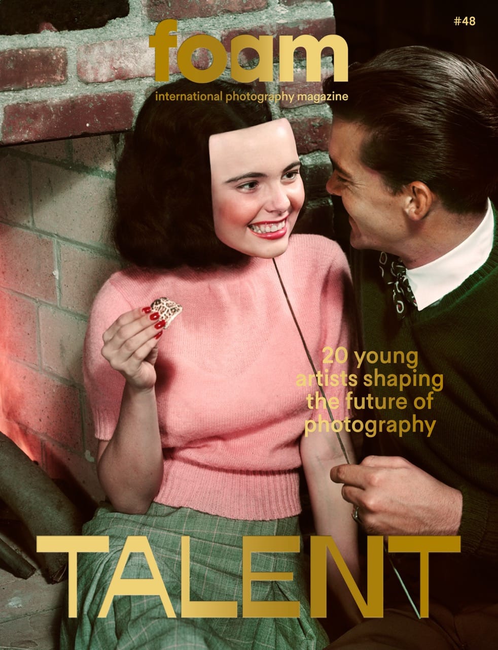 A woman in a pink sweater smiles while holding a small object, sitting next to a man in a green sweater. Text: "20 young artists shaping the future of photography."