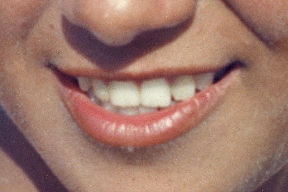 Archival image showing a close-up of the smile of the artist's mother. © Eleonora Agostini