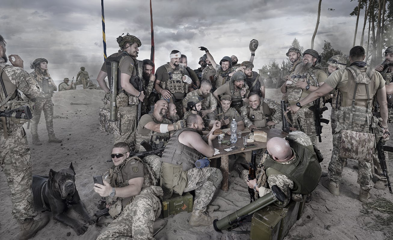 Large group of soldiers hanging out and laughing together