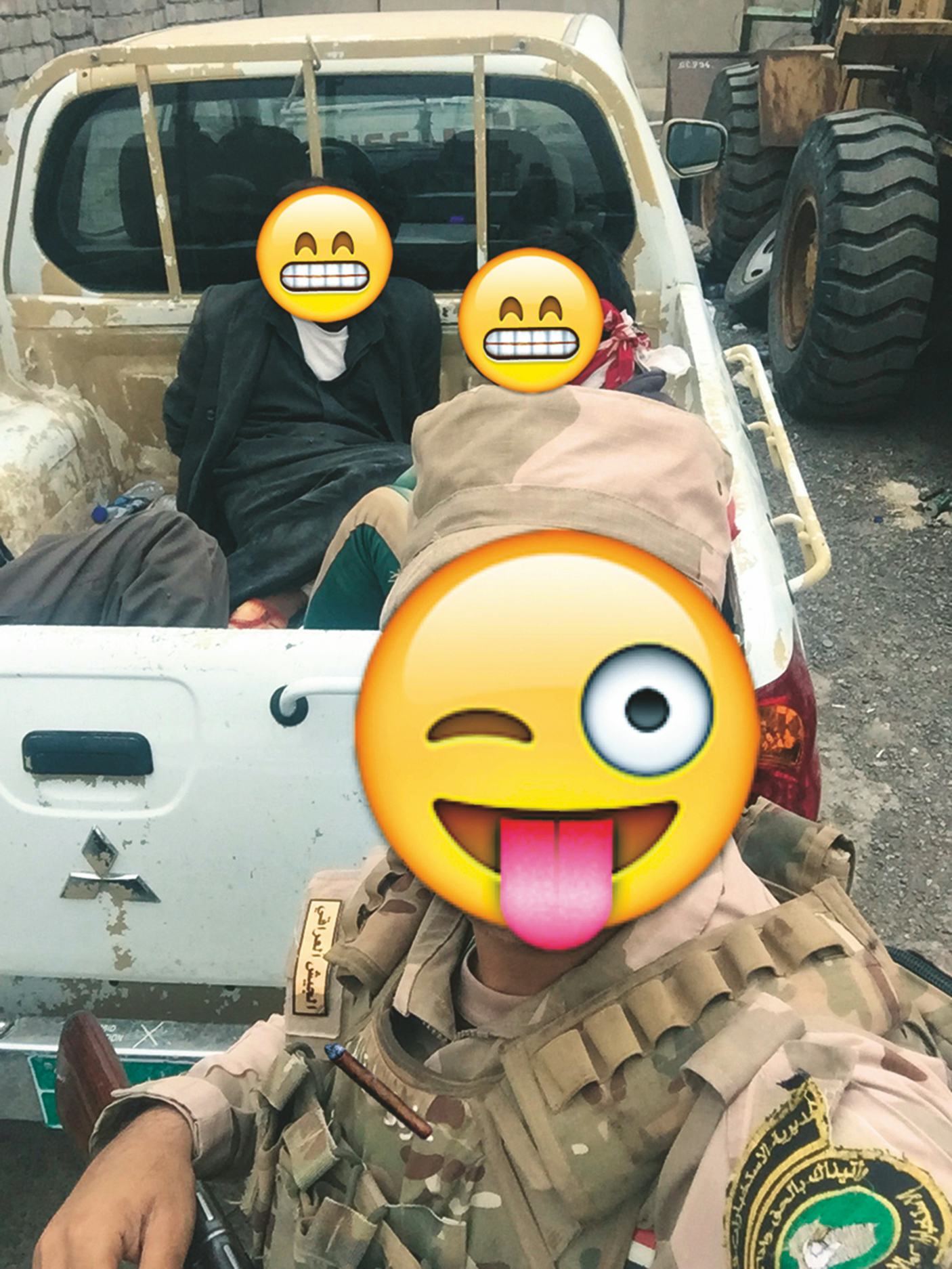 Selfie image of a soldier standing behind a truck, on which two men are kept captive. All three faces are covered by smiling and winking emojis.