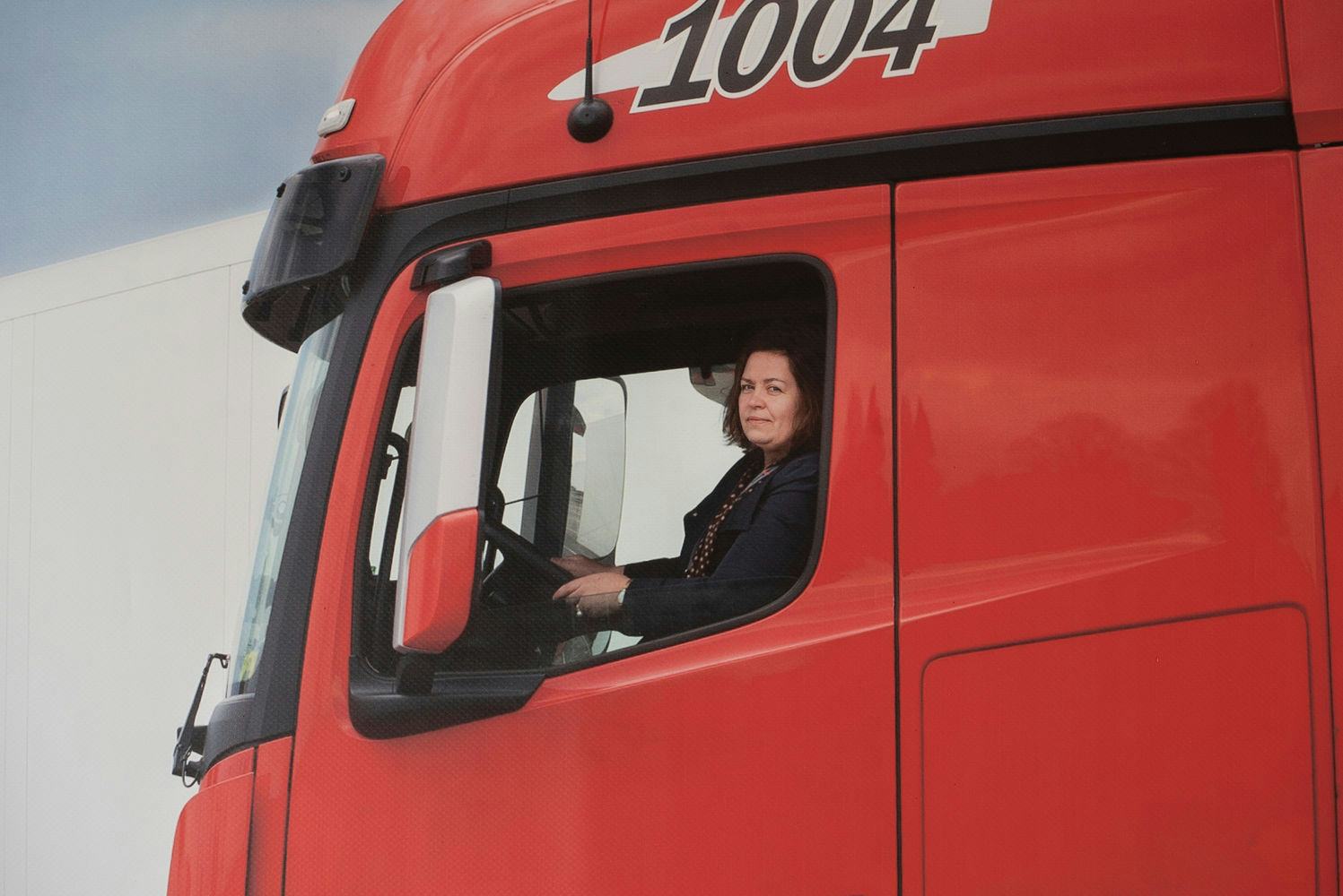 woman driving red truck