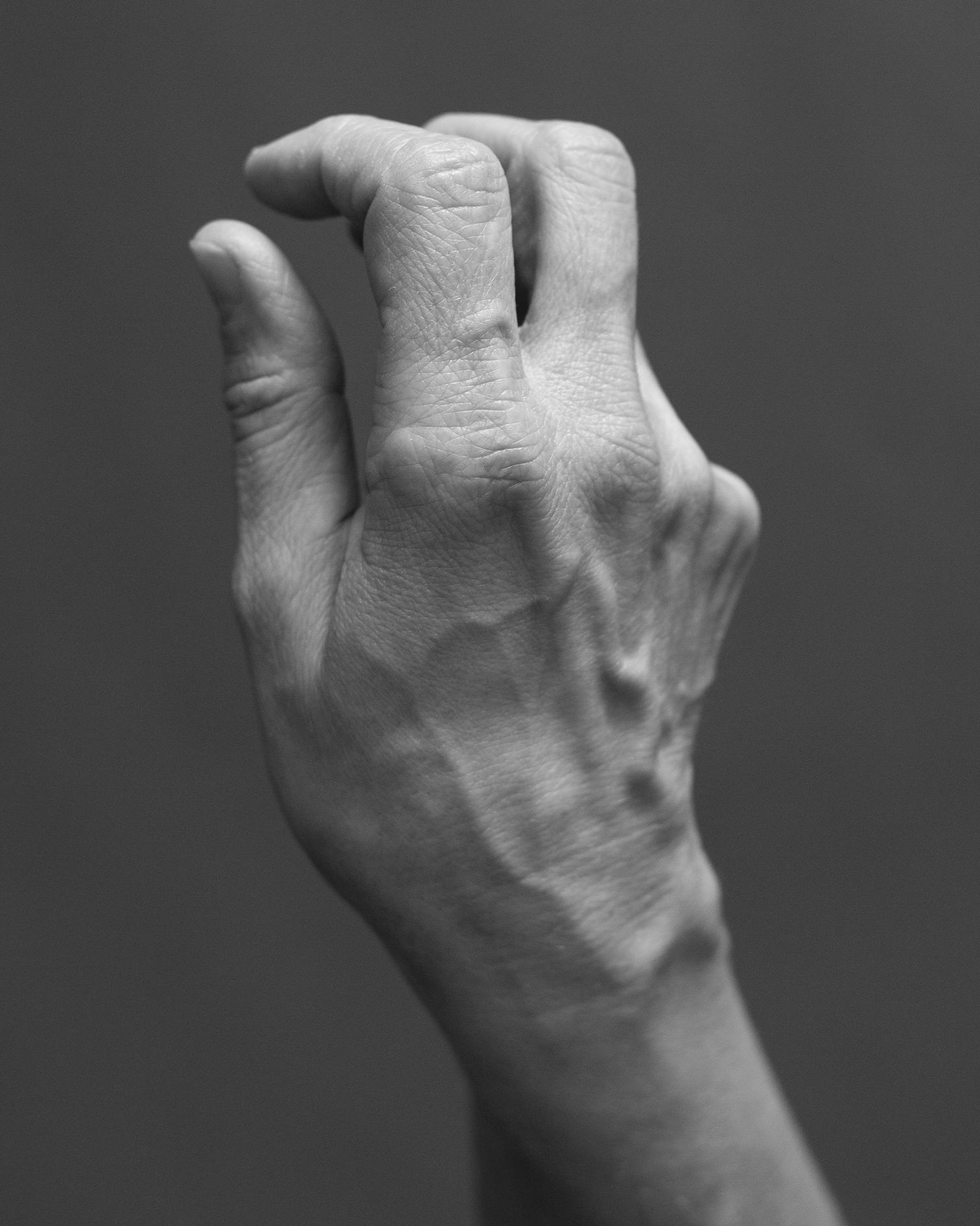 Black and white image of a gesturing hand. © Eleonora Agostini