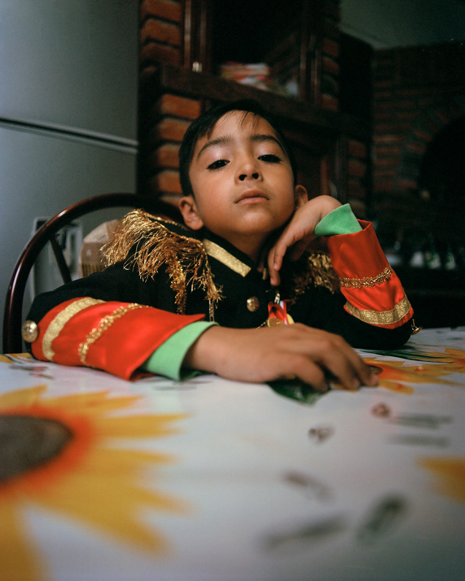 Boy sitting at table looking into the camera