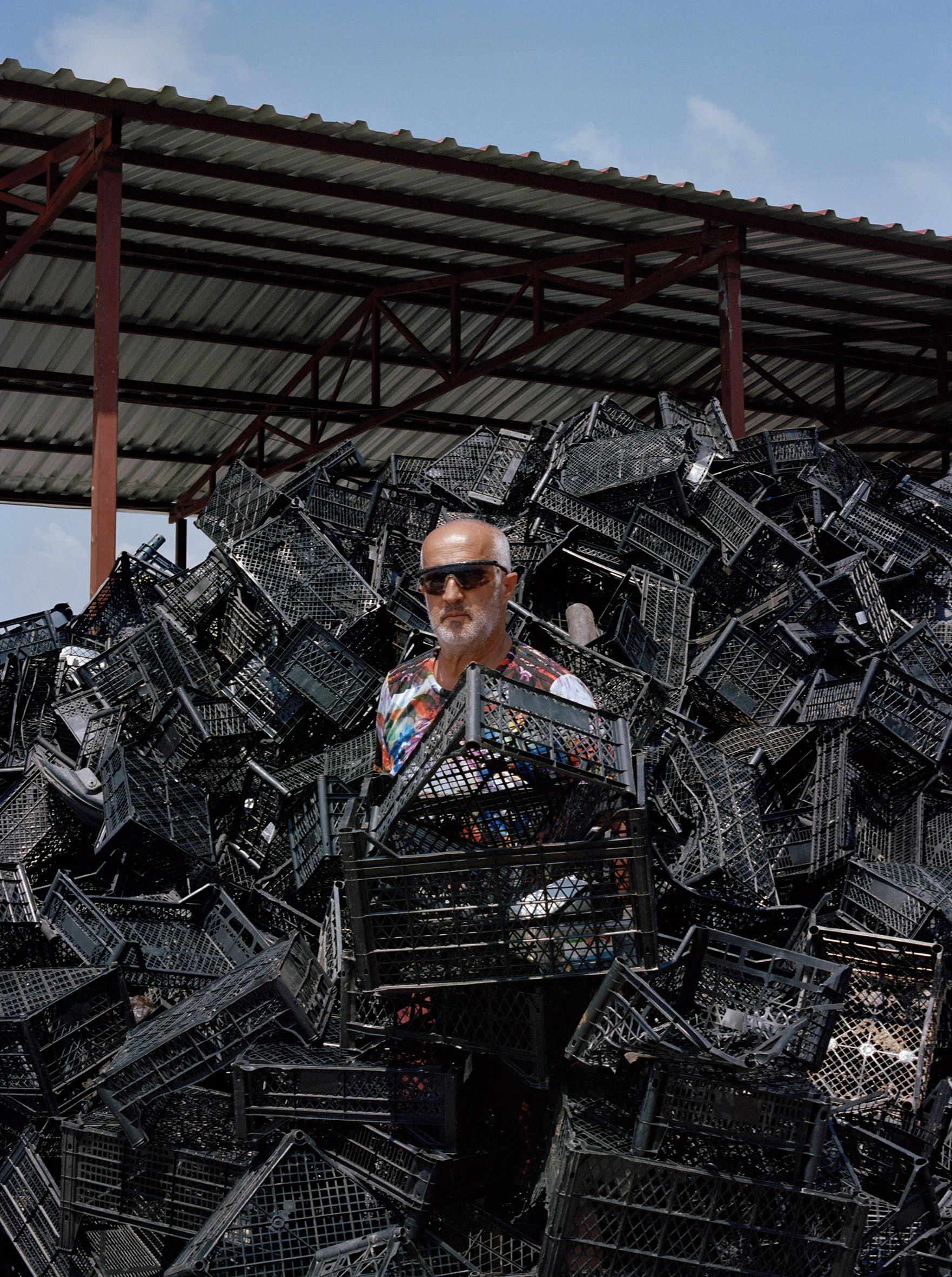 man standing between black crates with sunglasses on