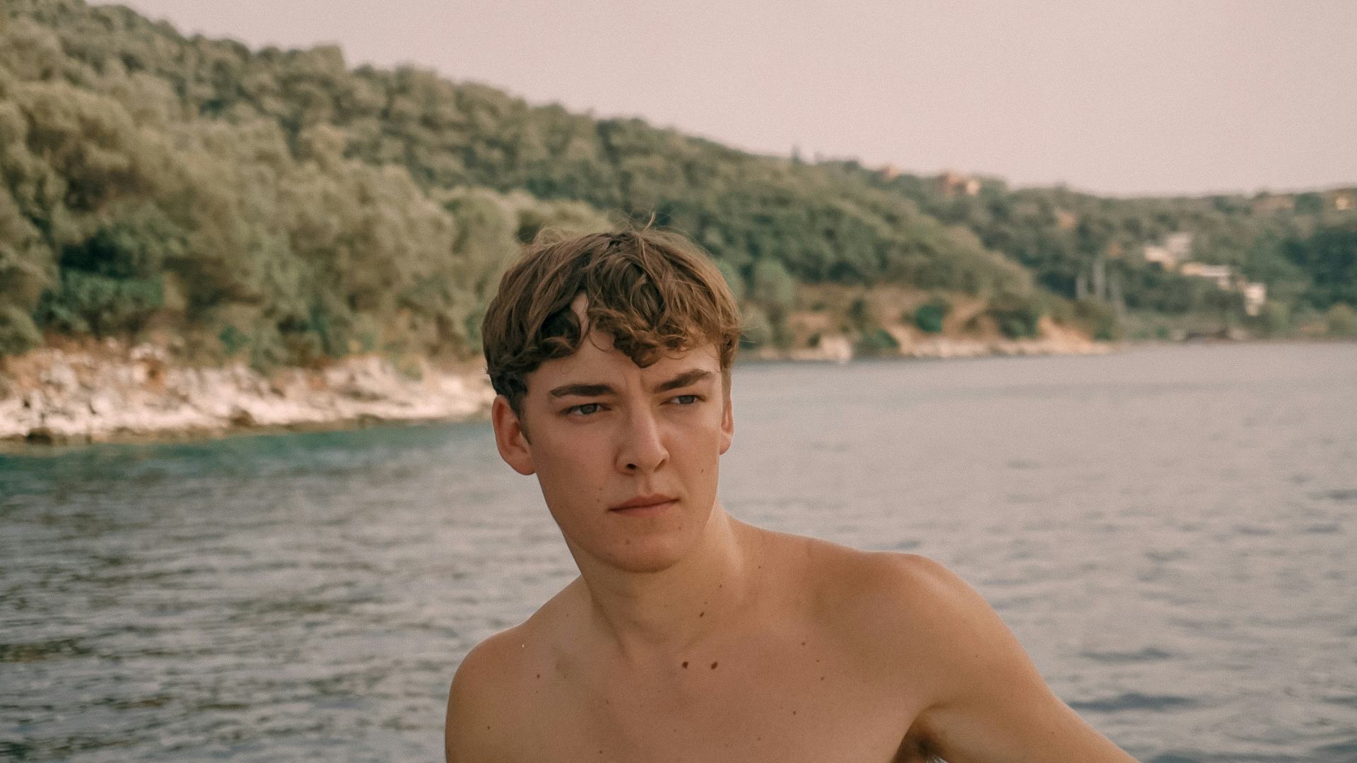 Portrait of a young white man in front of a seascape. © Tal Ben Yakir