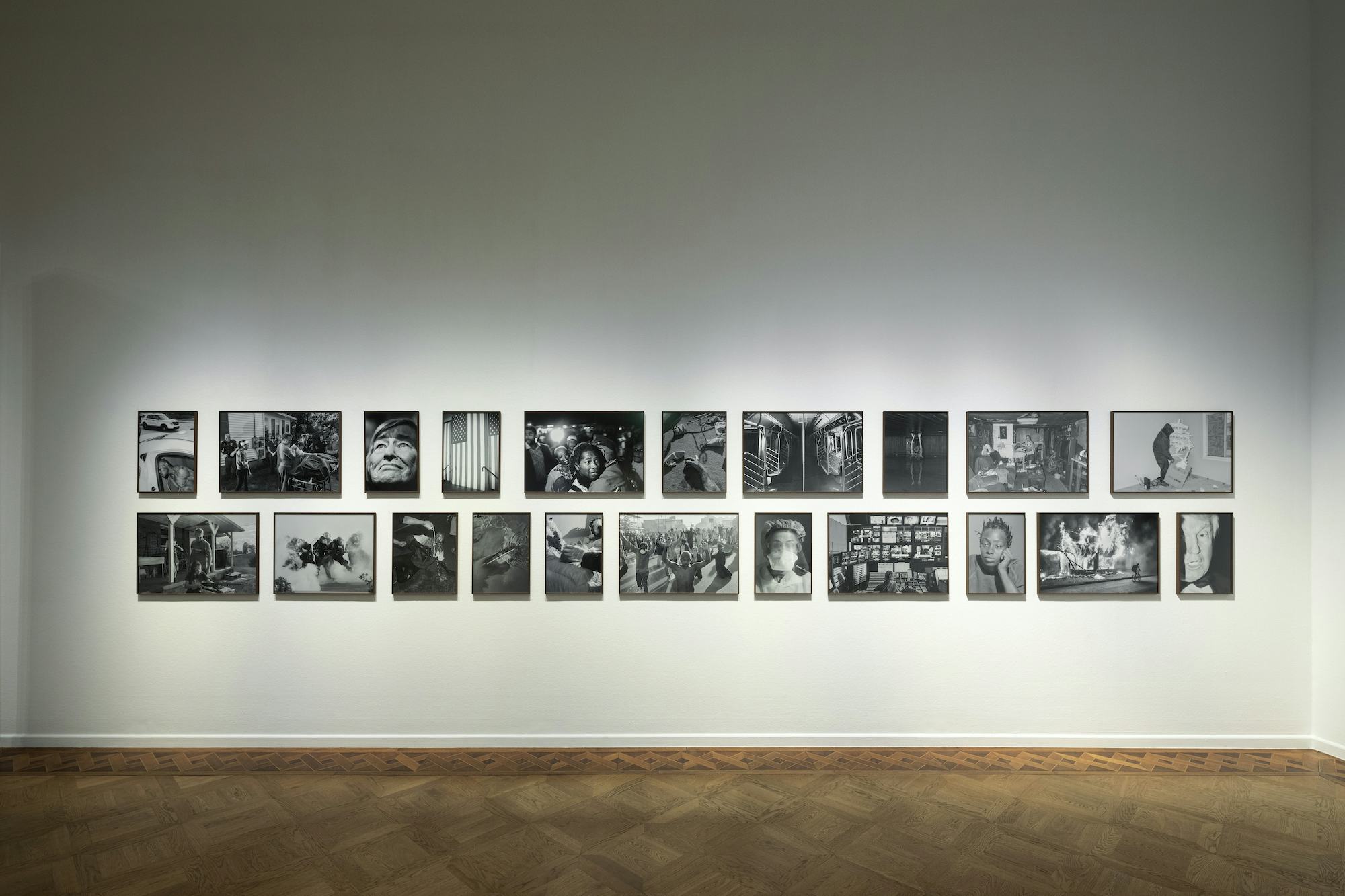 Installation shot of a series of black and white photographs by Philip Montgomery, presented on a white wall at Foam, Amsterdam