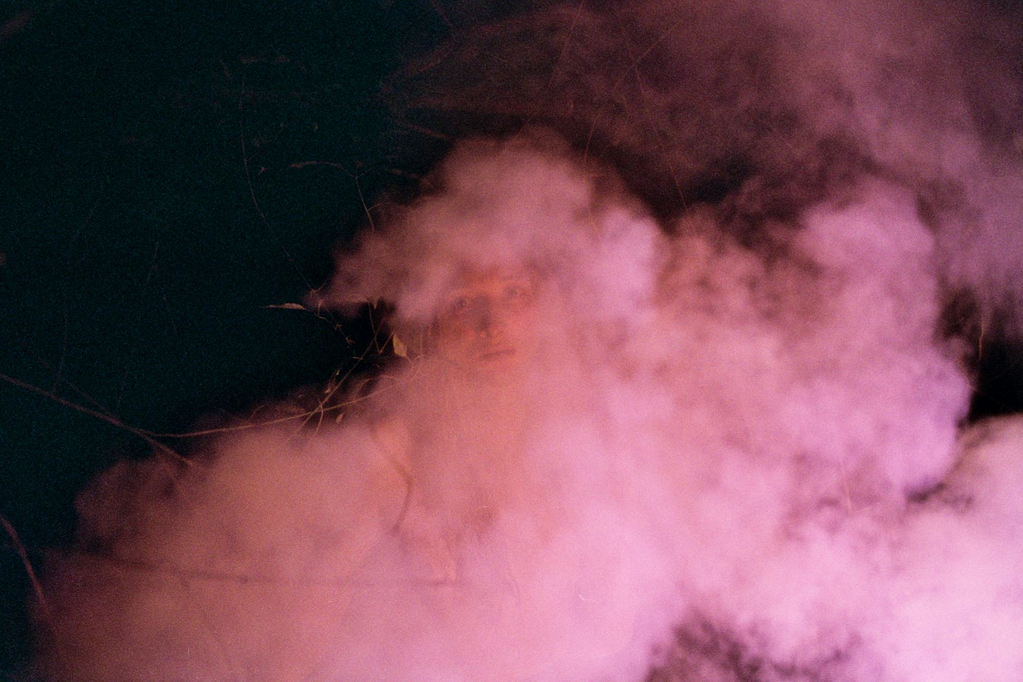 Picture of pink smoke, revealing a face in between © Cansu Yıldıran
