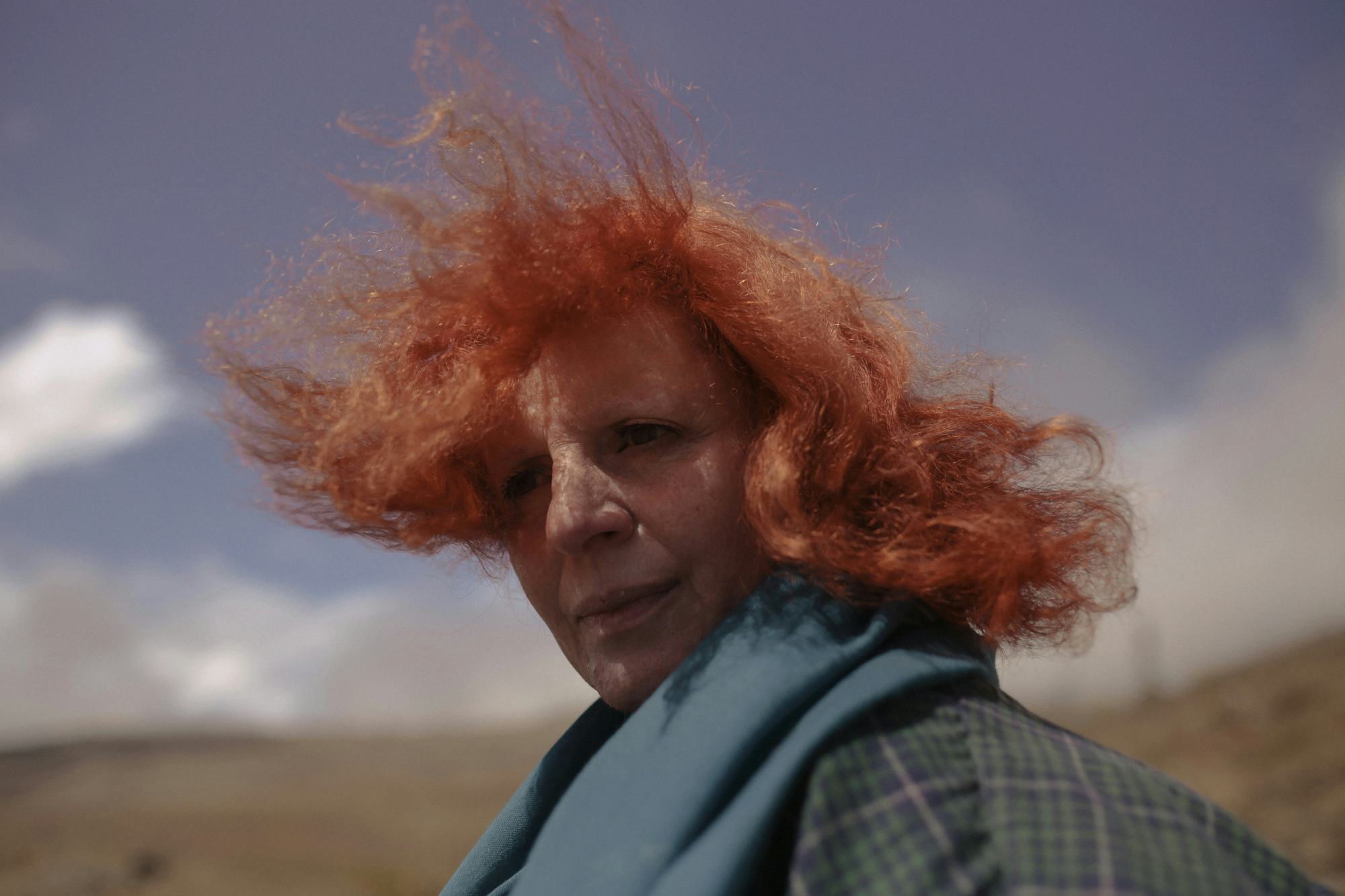 Portrait of the artist's mother, looking back at the camera, hair blowing in the wind. © Cansu Yıldıran