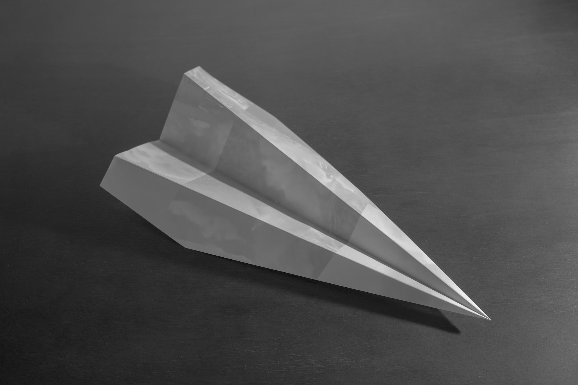 Black and white image of a paper plane, folded out of one of the collage sheets by Czar Kristoff