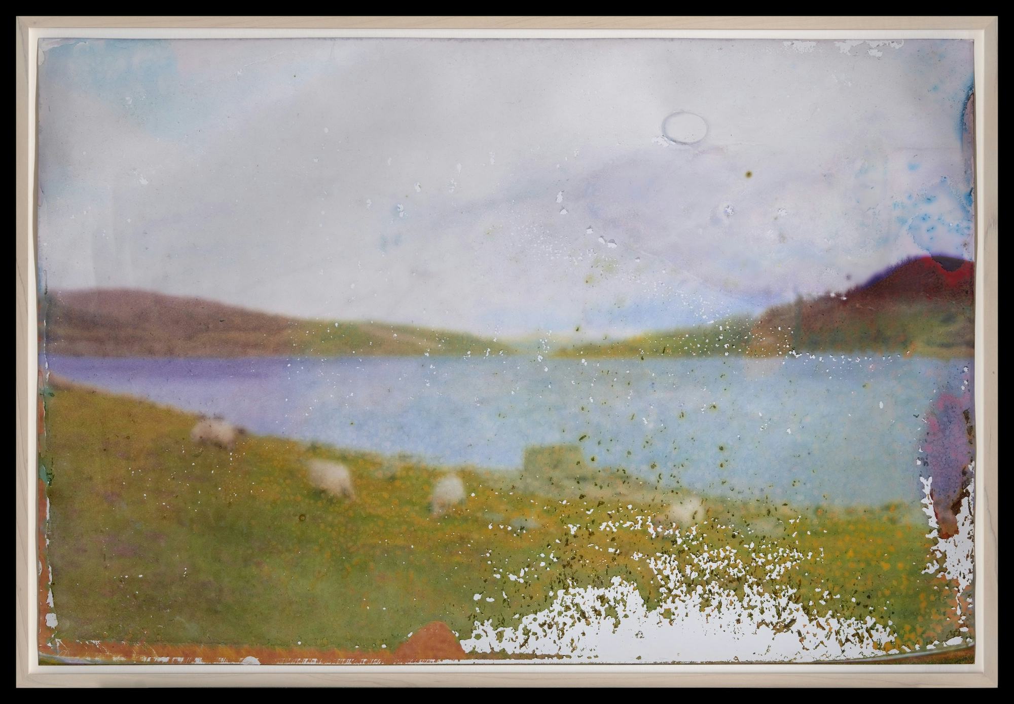 A landscape depicting lake and mountains. (The print is blurred on purpose.)