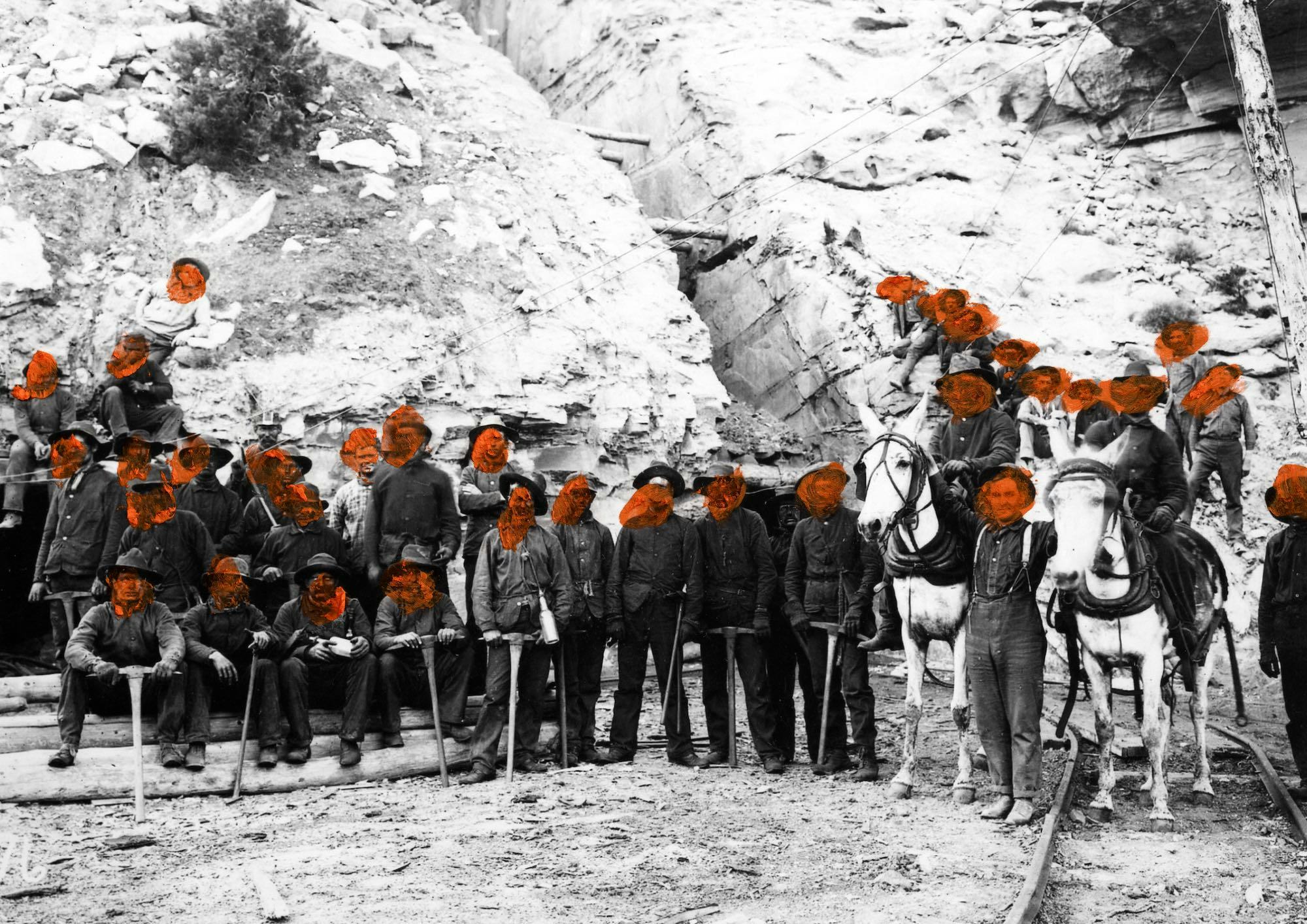 Archival photograph of a group of men, their faces covered with red paint © Jaclyn Wright