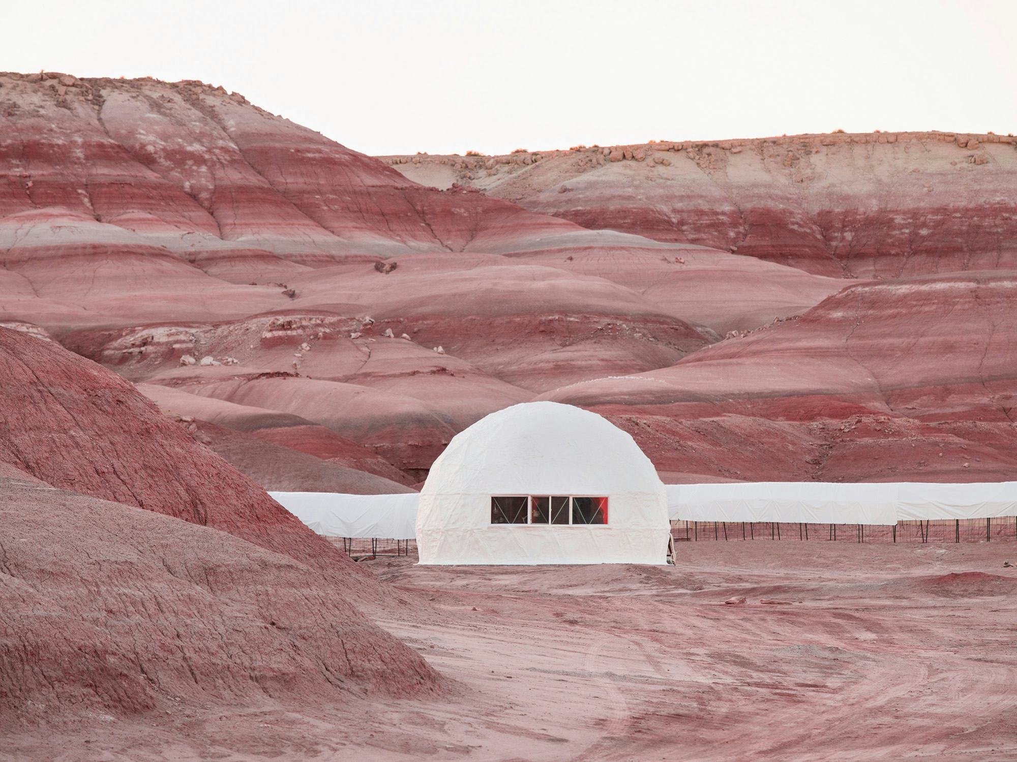Image of red mountainous landscape with a white dome in the middle © Andrea Orejarena & Caleb Stein