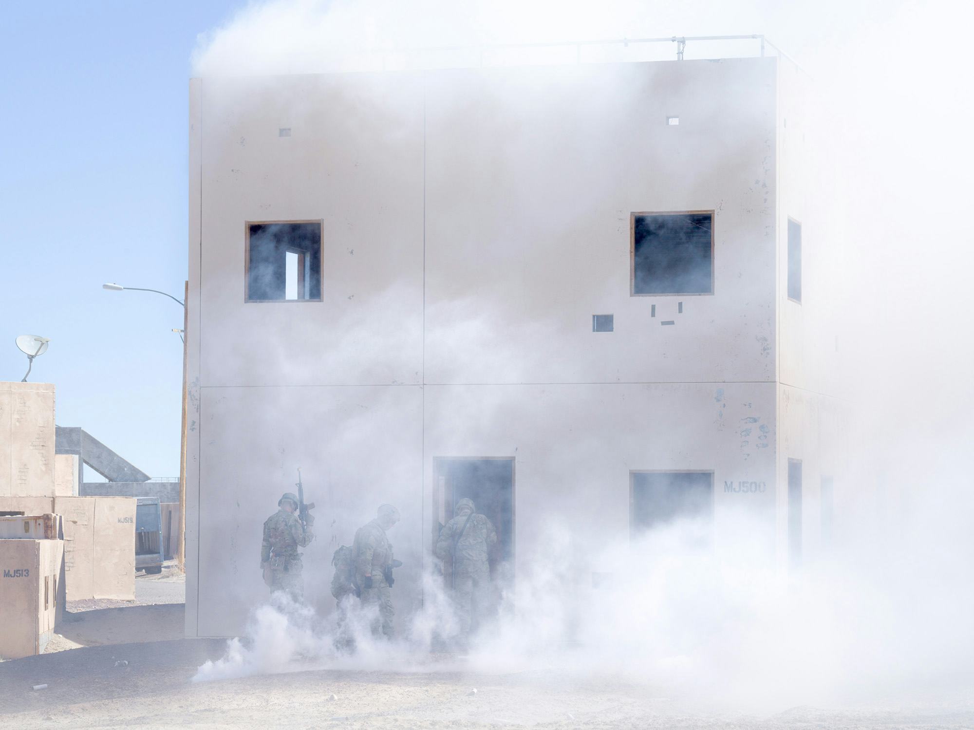 Image of a building covered in smoke. © Andrea Orejarena & Caleb Stein