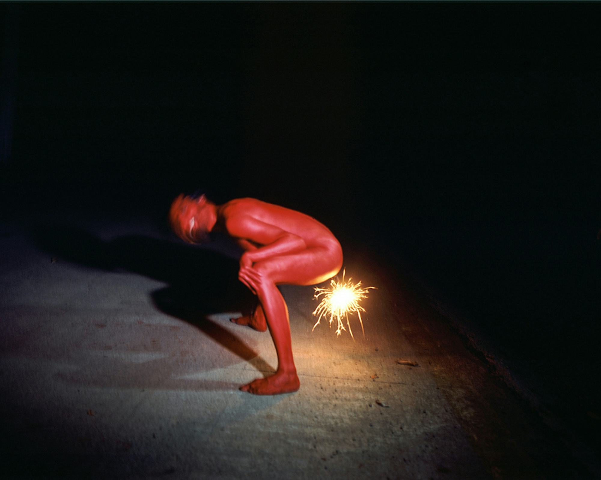 Picture of a squatting person, coloured red, that appears to be pooping fireworks © Cansu Yıldıran
