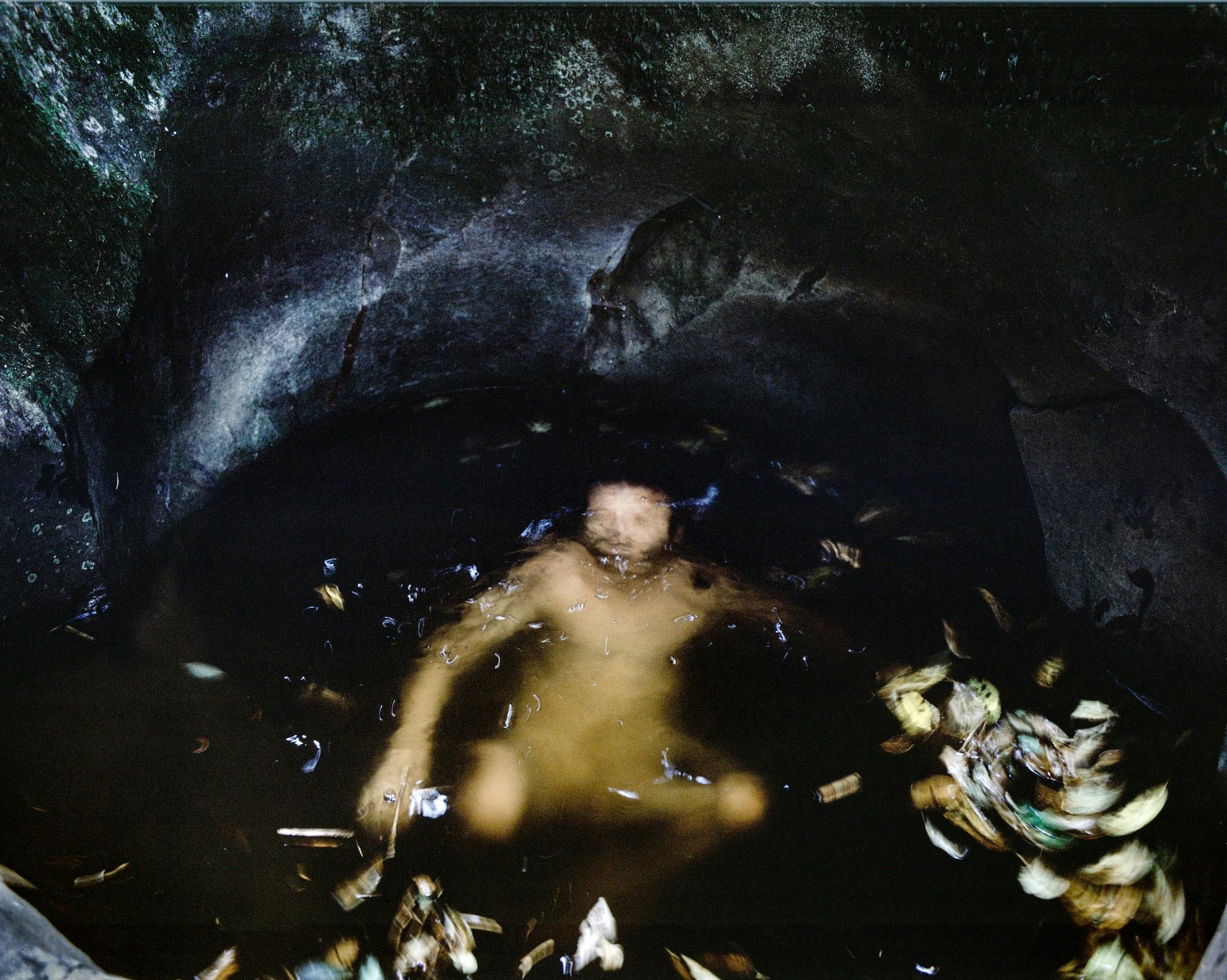 Picture of a person submerged in water in a cave © Cansu Yıldıran