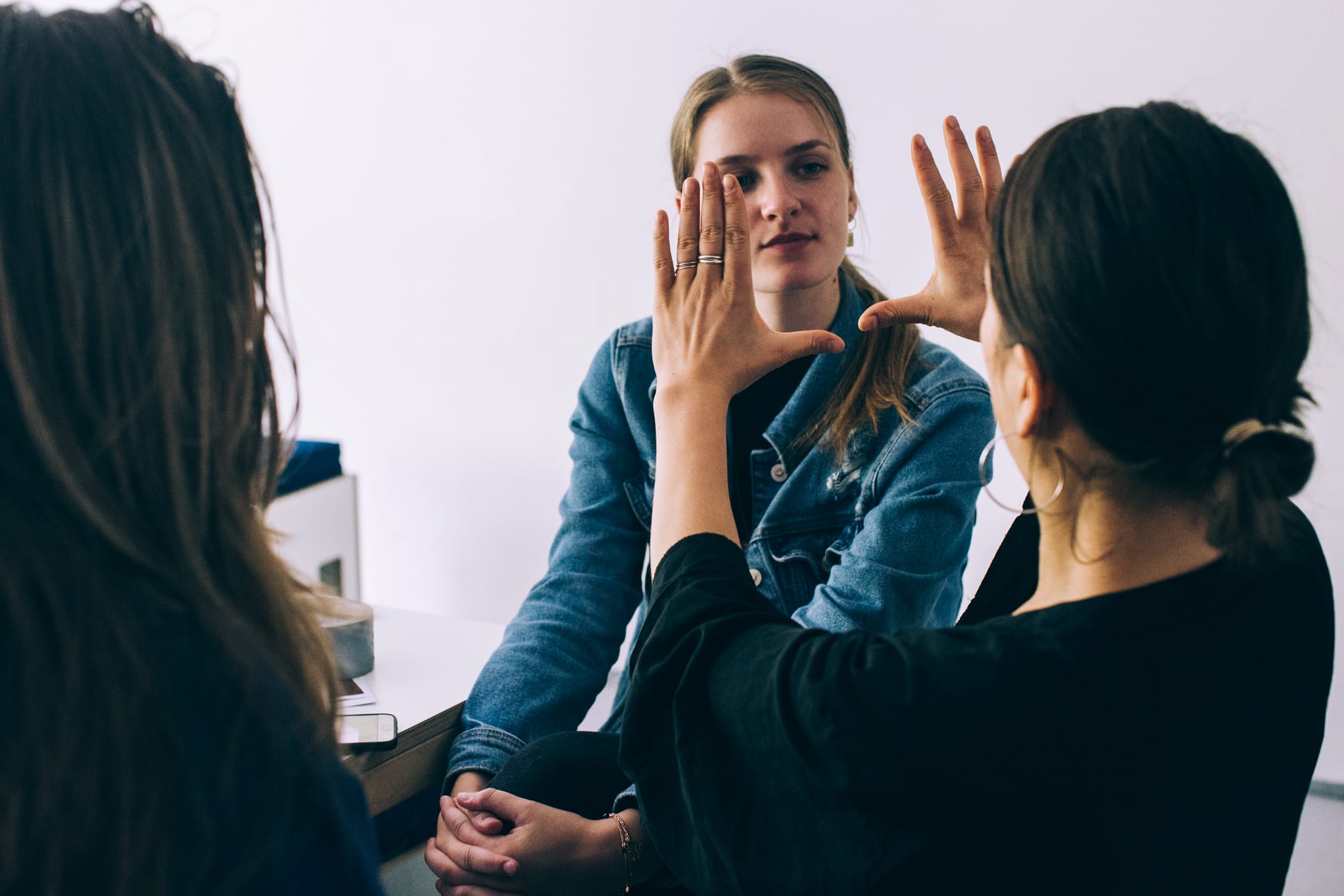 Portrait of someone framed between the hands of another person.