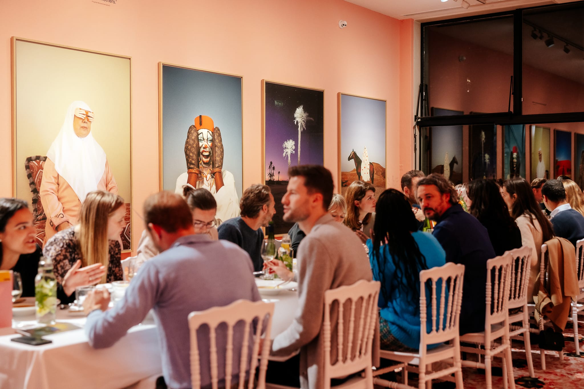 Long dining table full of people enjoying a meal in the exhibition halls.
