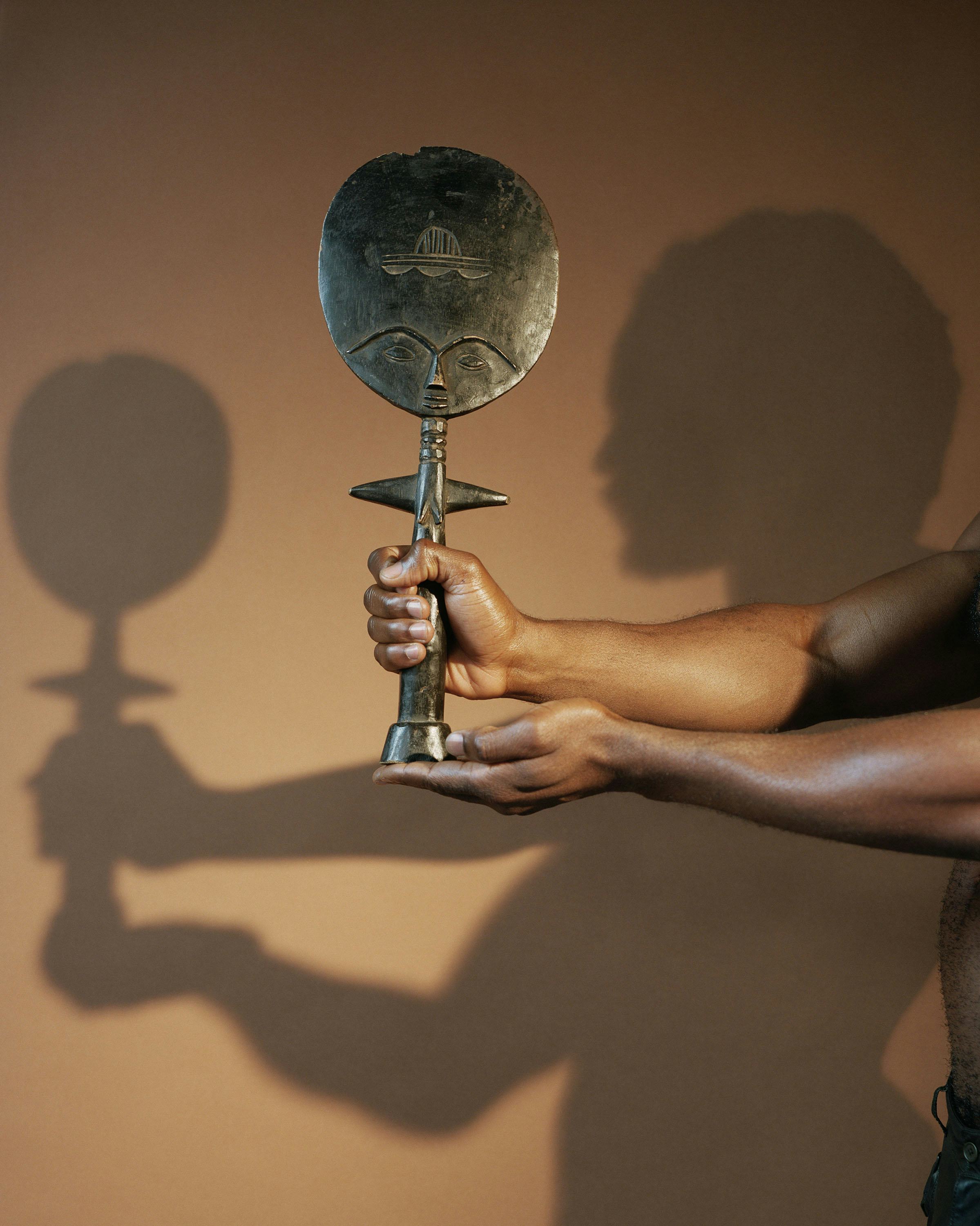 Holding a sculpture from the Ashanti 2019 C John Edmonds