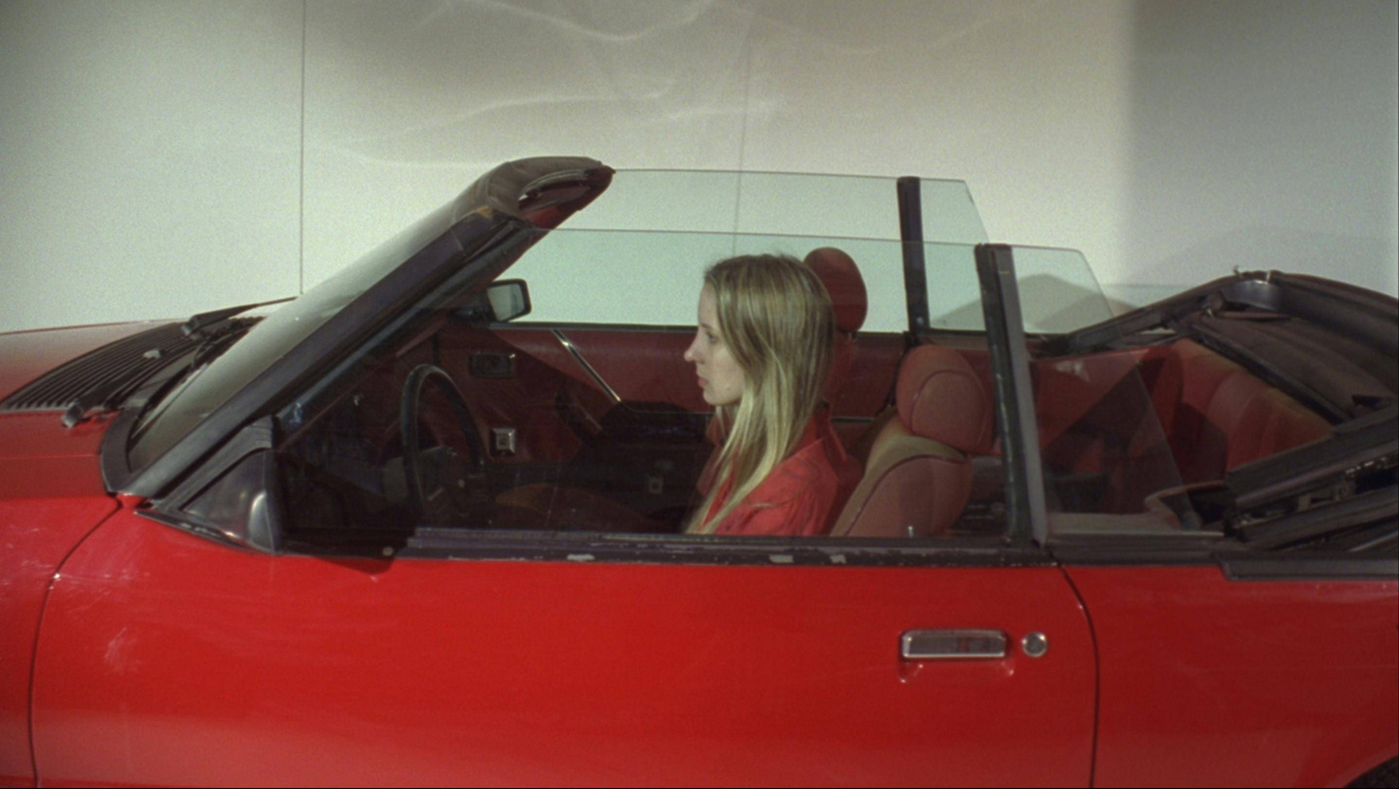 sara cwynar in red car still from red video