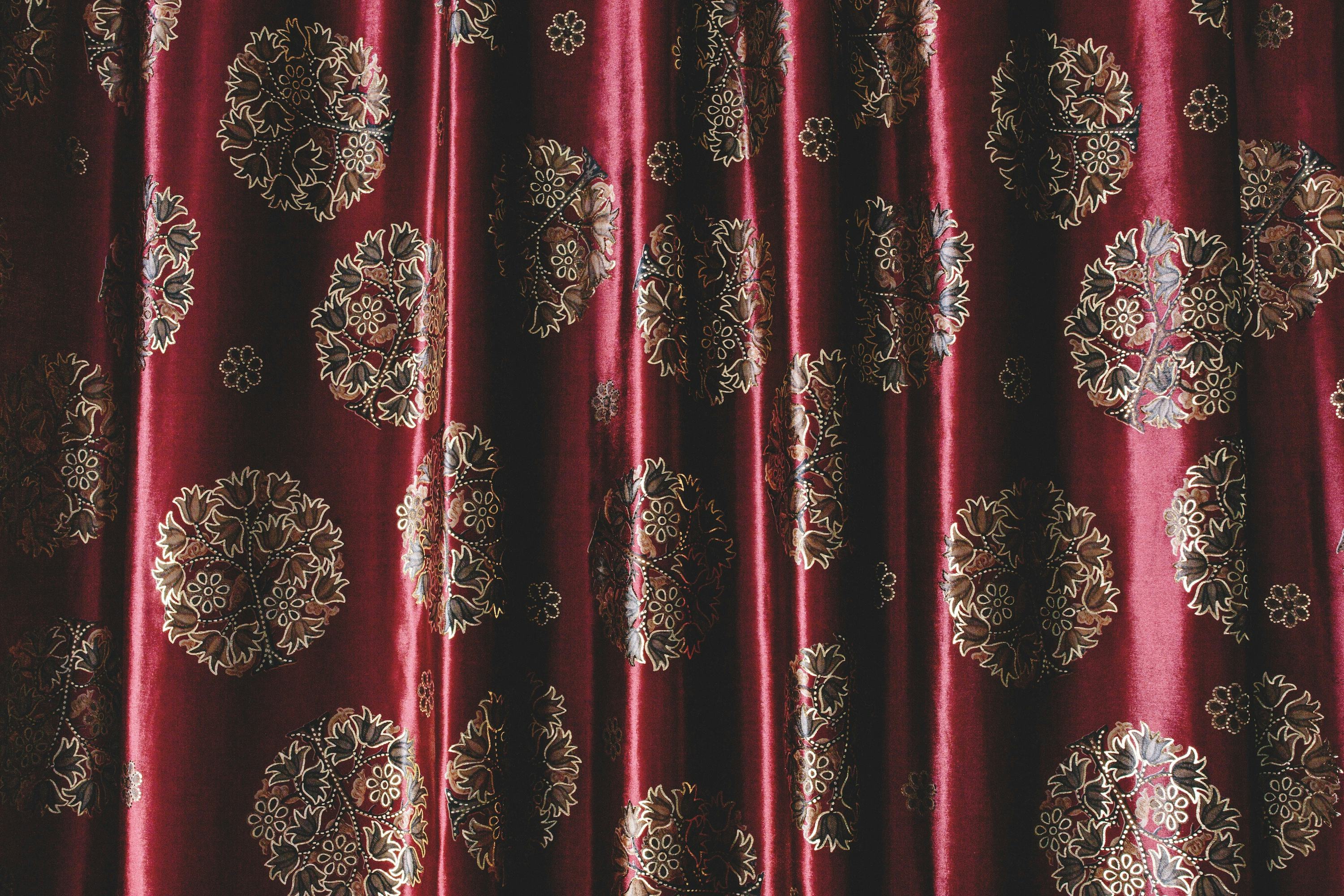 Burgundy coloured curtain with embroidered motives